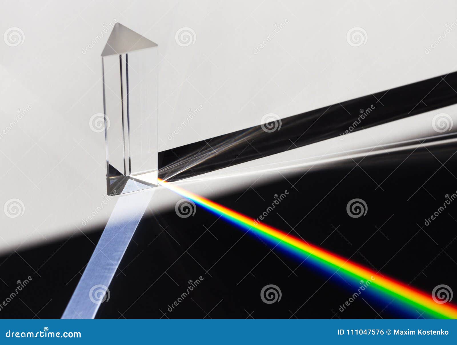 a prism dispersing sunlight splitting into a spectrum on a white background.