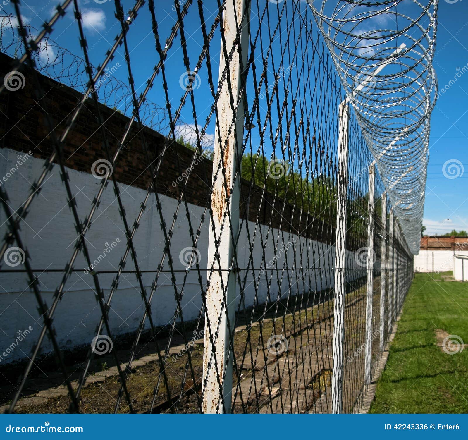 Prison security facilities. Barbed-wire and brick walls in order to secure prison area.