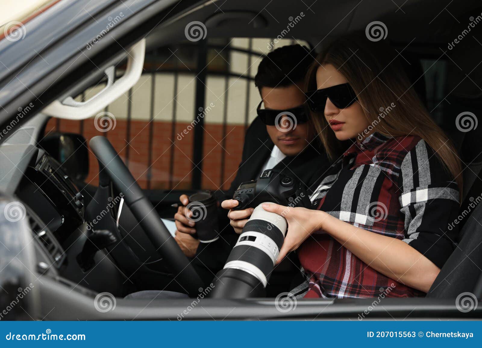 private detectives with modern camera spying from car