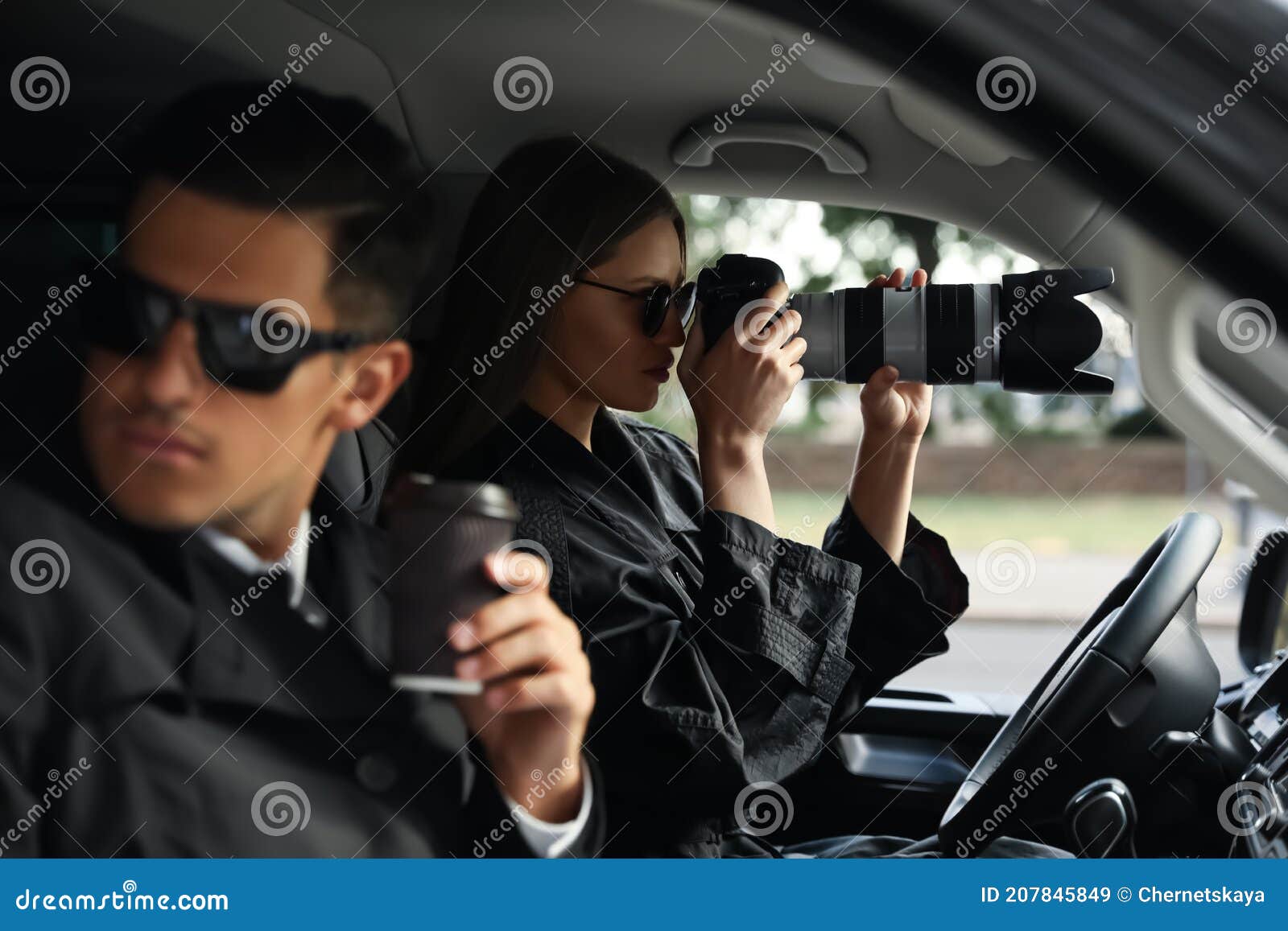 private detectives with modern camera spying from car