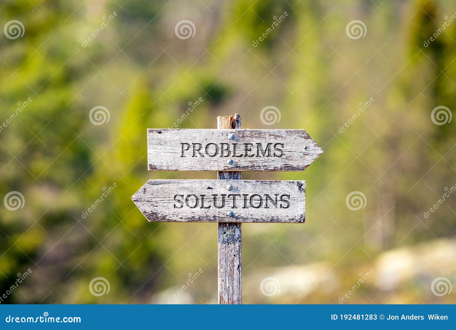 problems solutions text carved on wooden signpost outdoors in nature