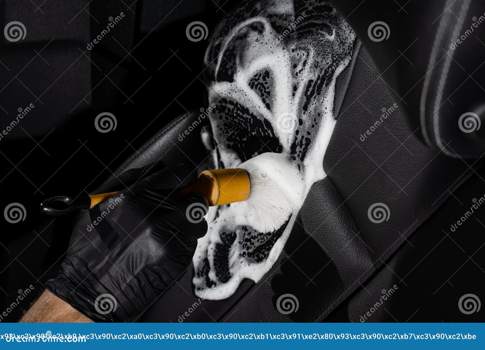 Process of Applying Foam and Detergent on Black Leather Seat Using