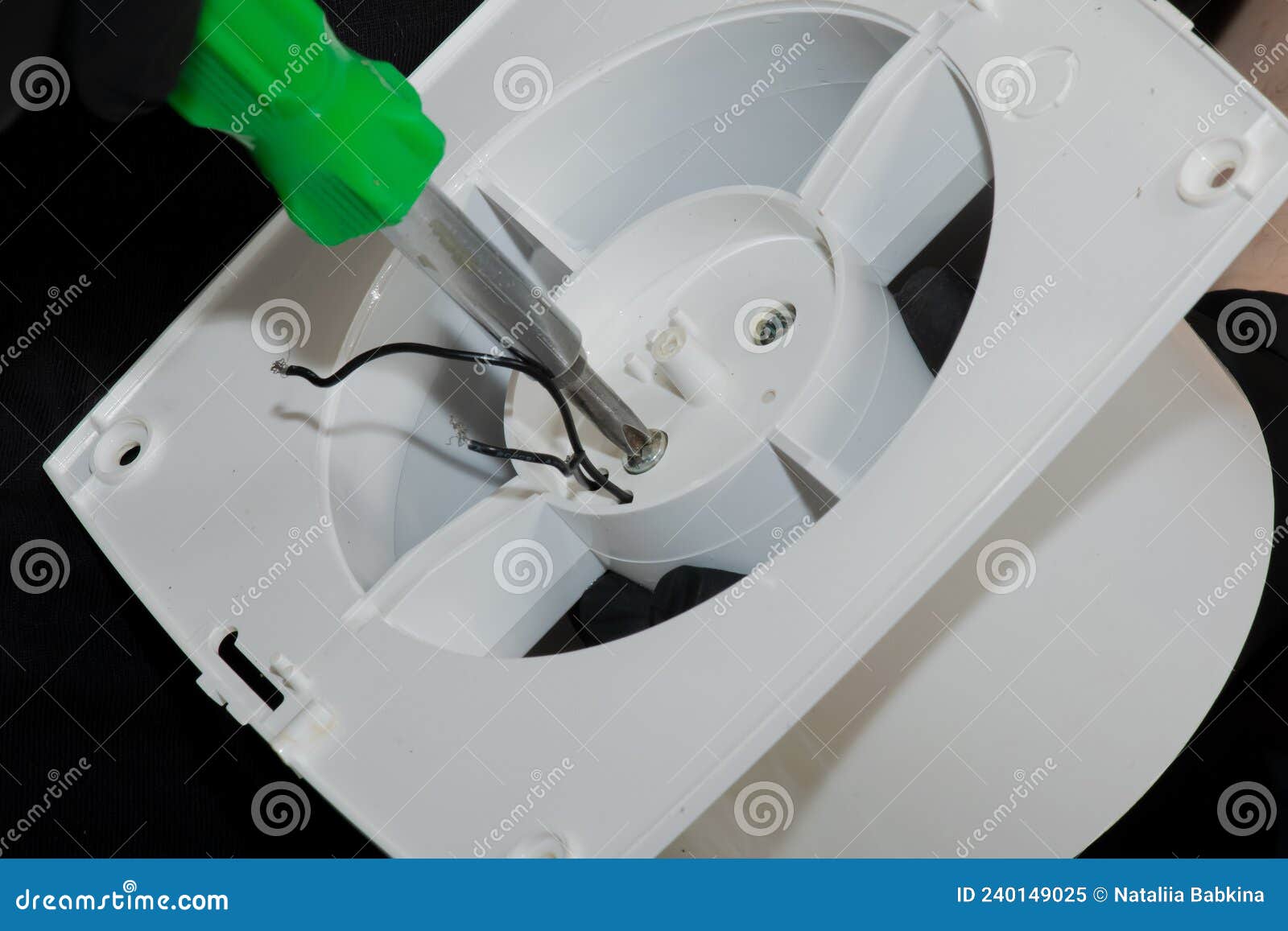 The Process of Assembling the Kitchen Exhaust Fan after Cleaning the
