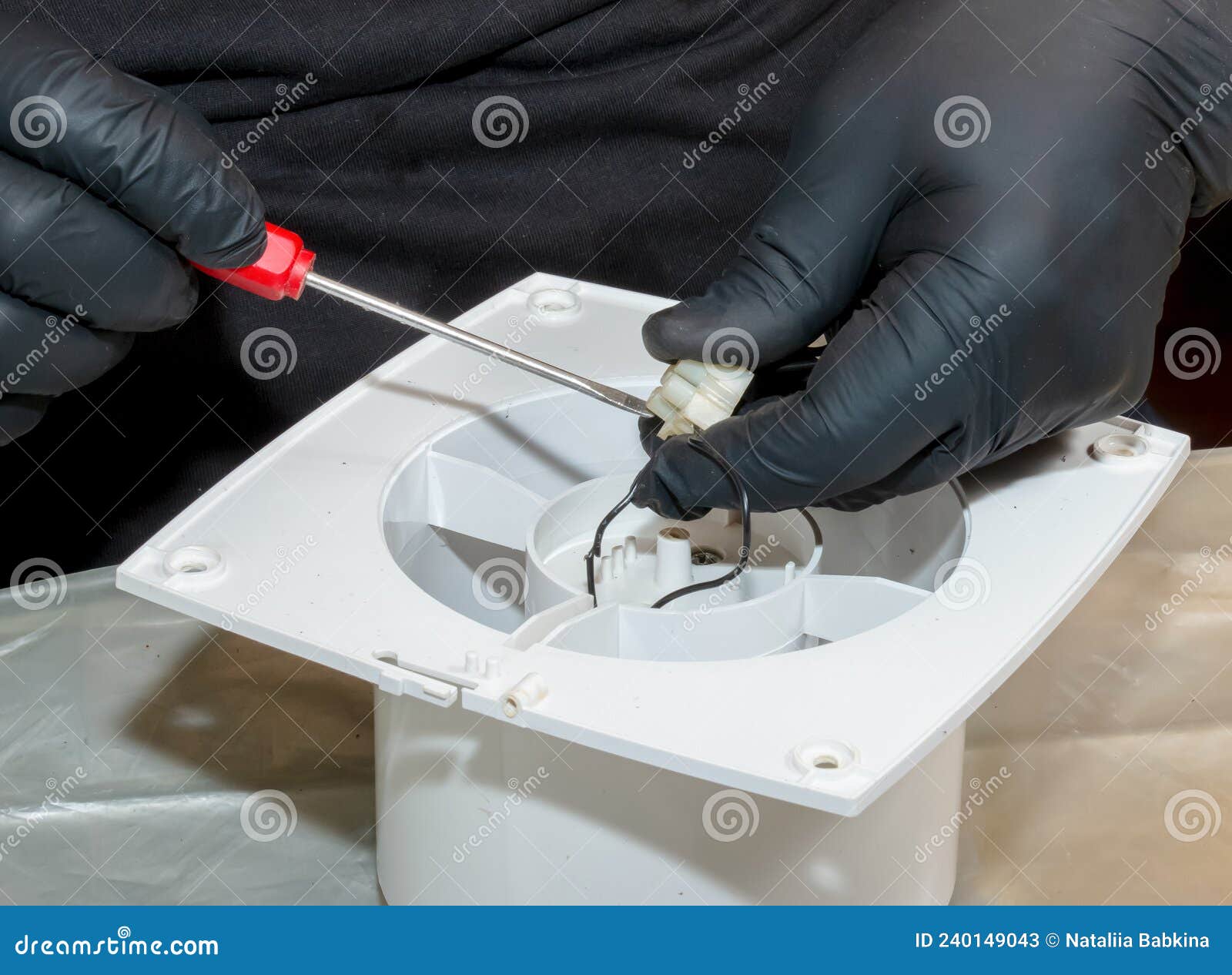 The Process of Assembling the Kitchen Exhaust Fan after Cleaning the