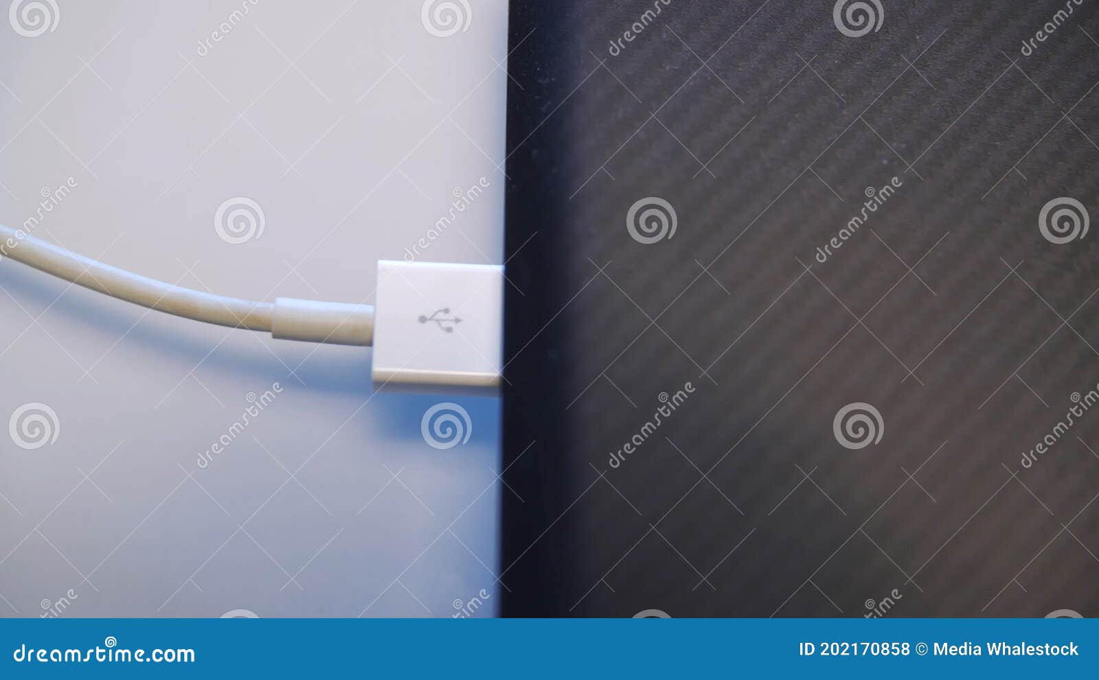 Process of Charging Device with a White USB Cable. Media. Close Up of