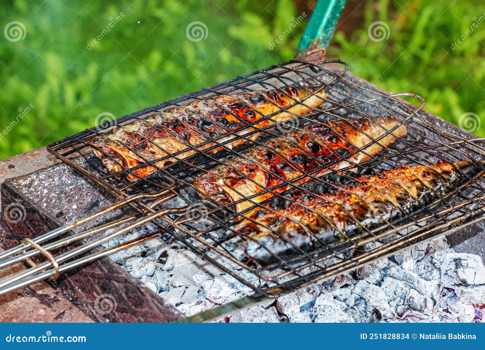 The Process of Cooking Mackerel Fish in a Marinade on the Grill. the