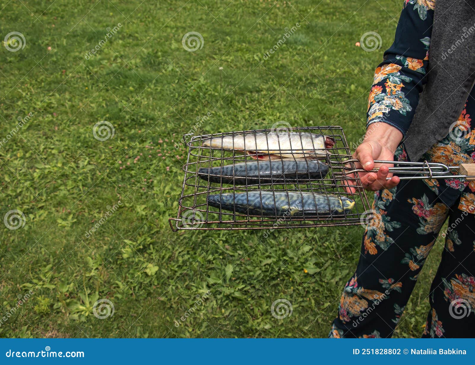 The Process of Cooking Mackerel Fish in a Marinade on the Grill. the