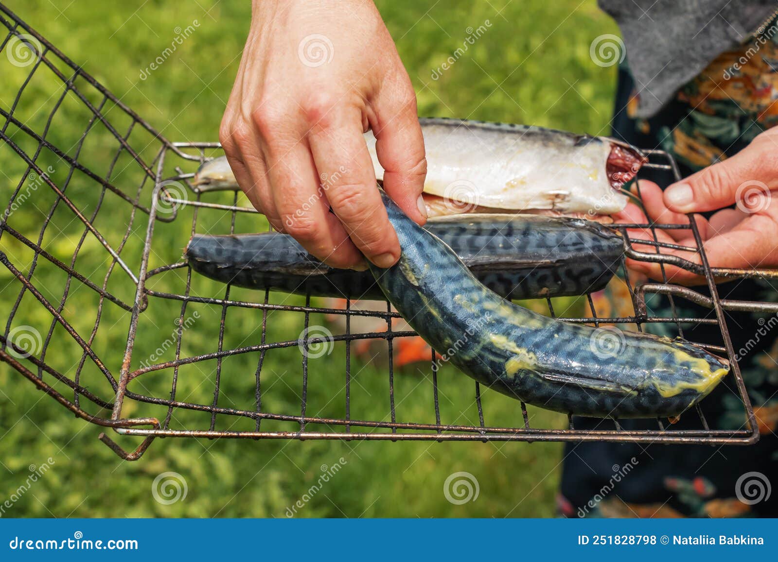 The Process of Cooking Mackerel Fish in a Marinade on the Grill. the