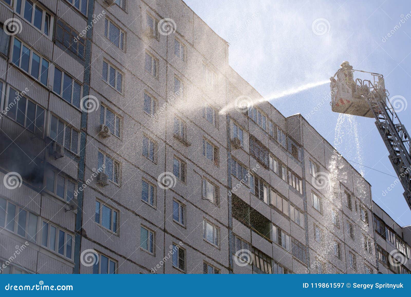 Fireman Extinguishes a Fire in an Apartment Building Stock Image