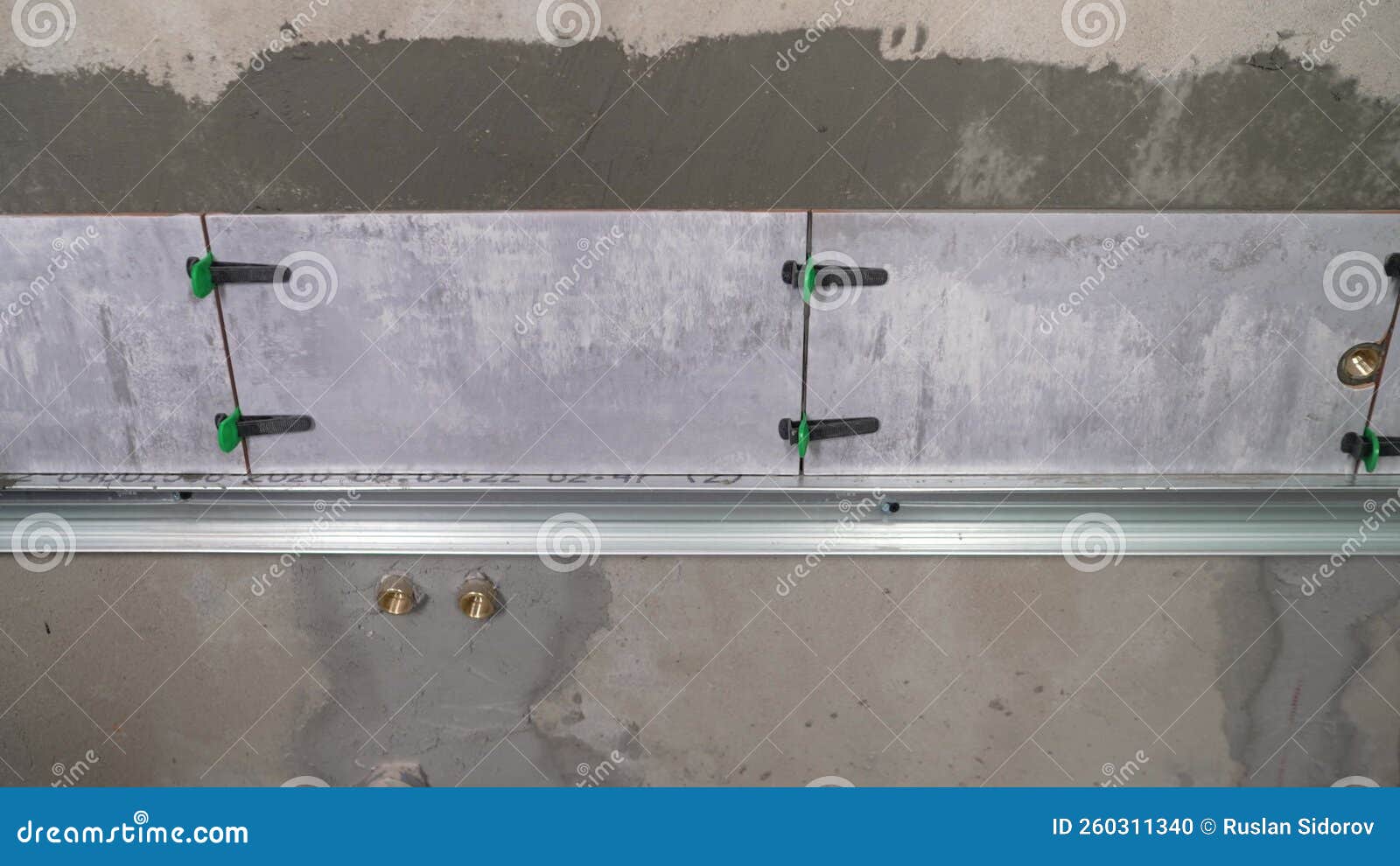 The Process of Gluing Tiles on the Wall. Installing Ceramic Tiles on