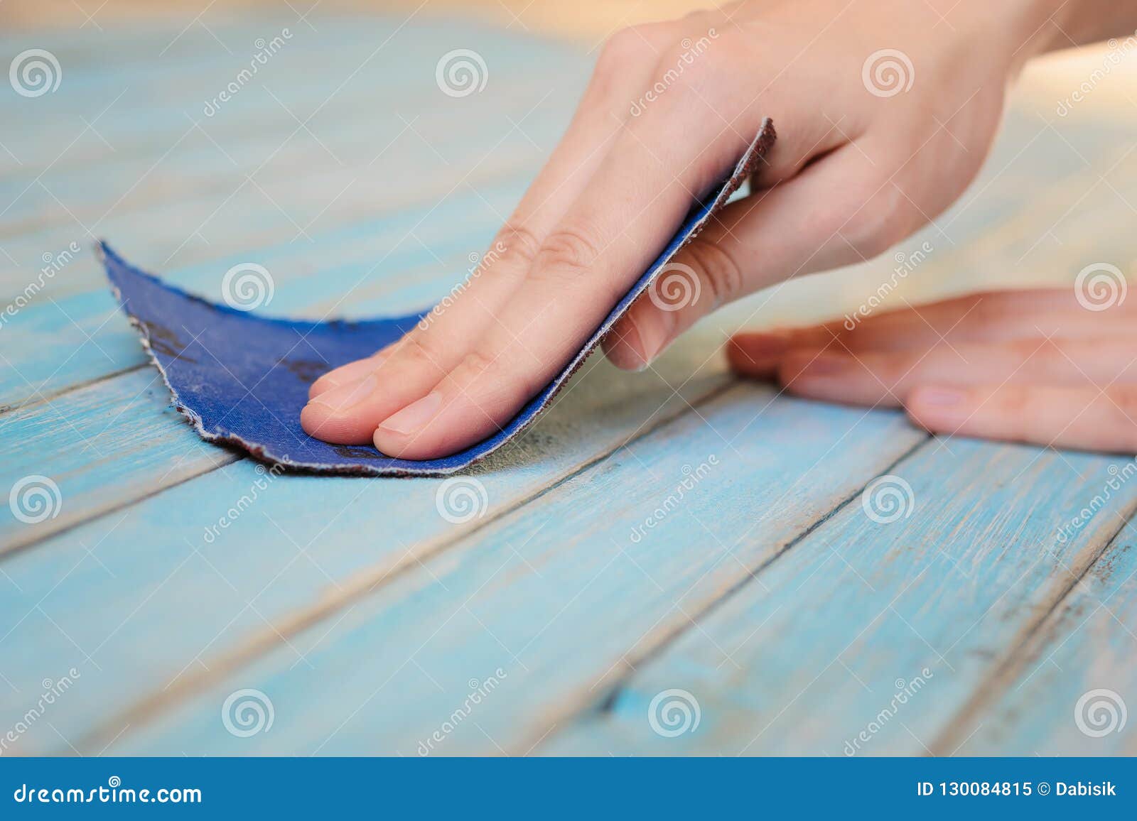 Process of Hand Polishing Wooden Board Surface with a Sandpaper Stock
