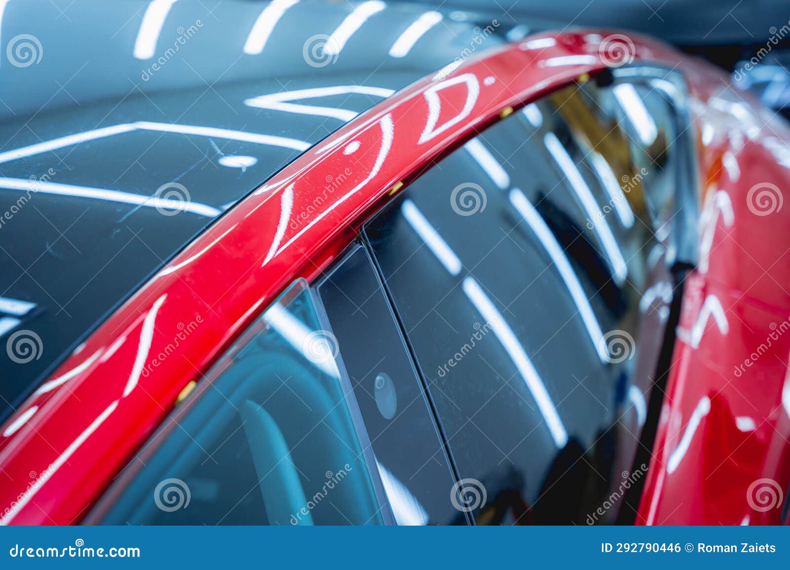 The Process of Installing Protective Film on the New Red Car. Stock