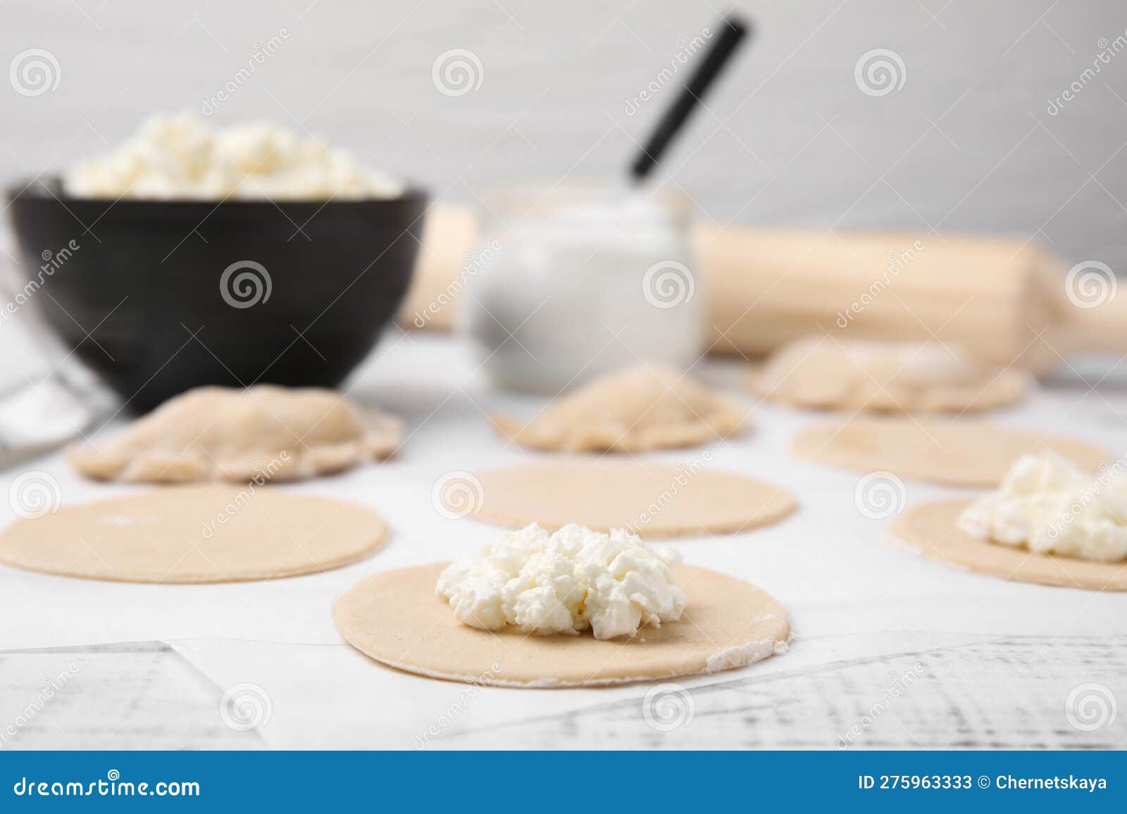 Process of Making Dumplings (varenyky) with Cottage Cheese. Raw Dough and Ingredients on White