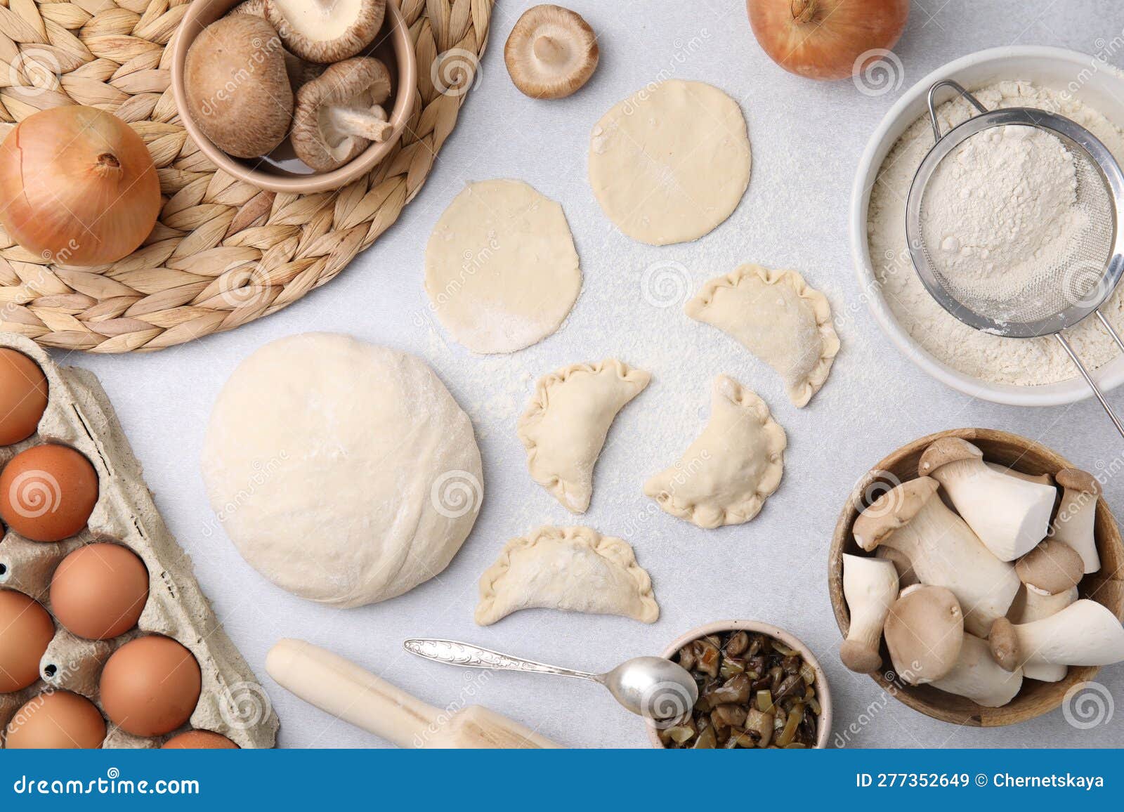 Process of Making Dumplings (varenyky) with Mushrooms. Raw Dough and Ingredients on White Table