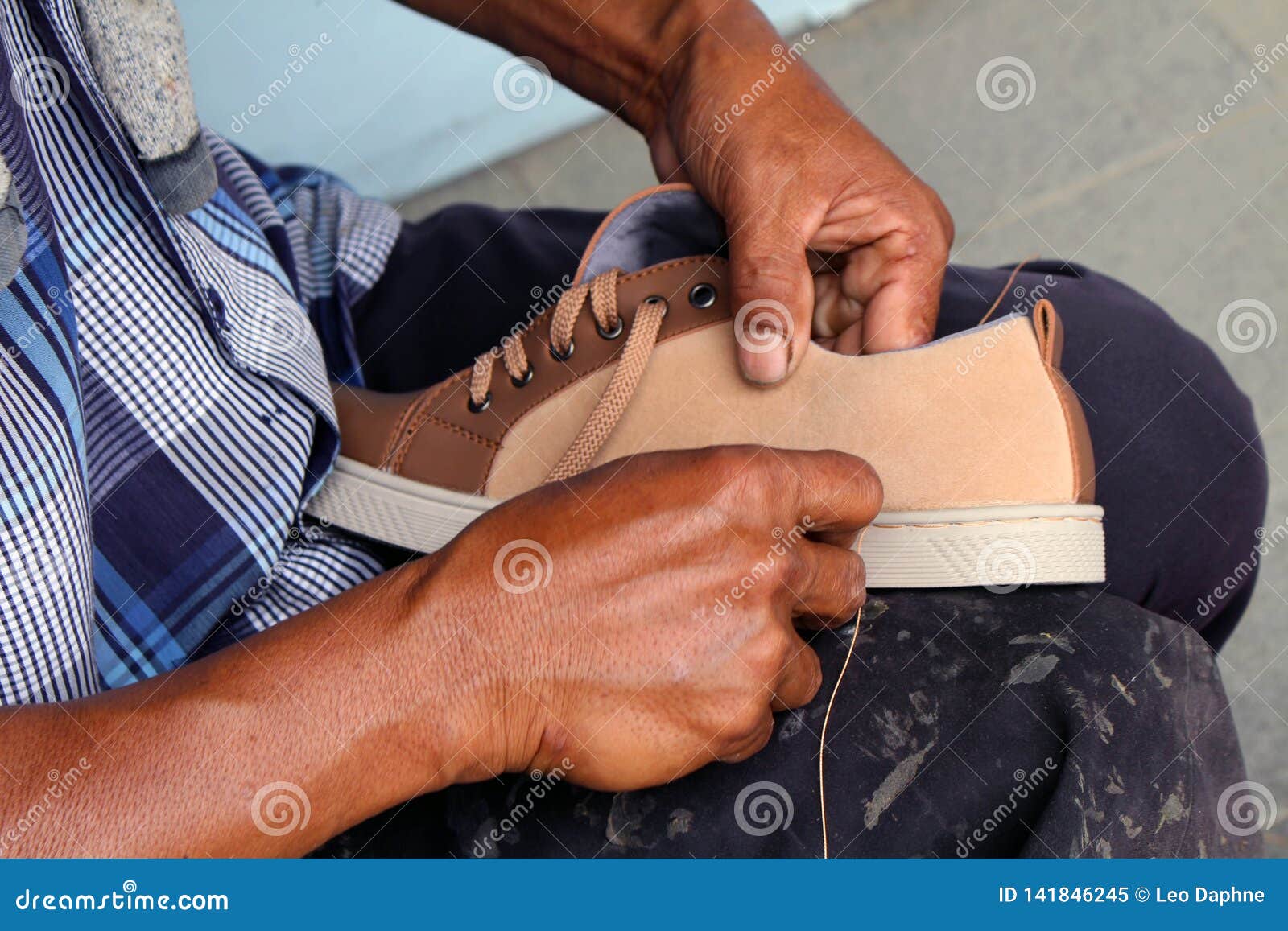 process of manual shoe reparation, sole and welt fixing and stitching