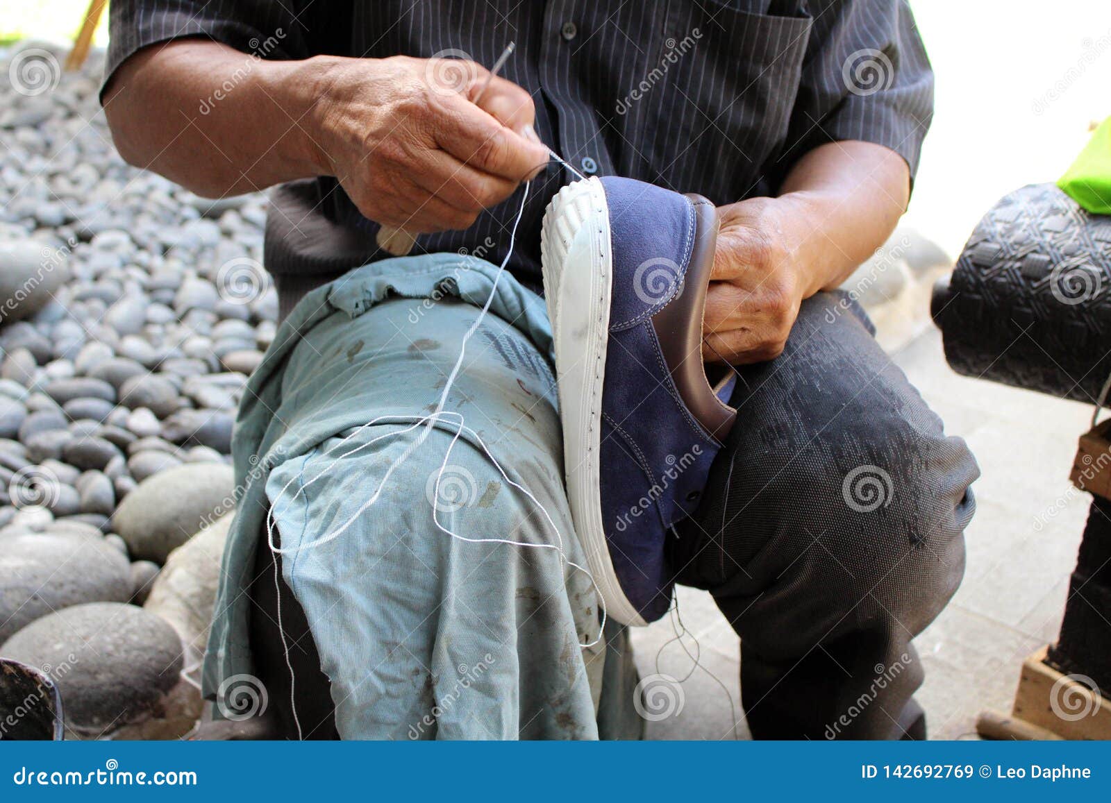 process of manual shoe reparation, sole and welt fixing and stitching
