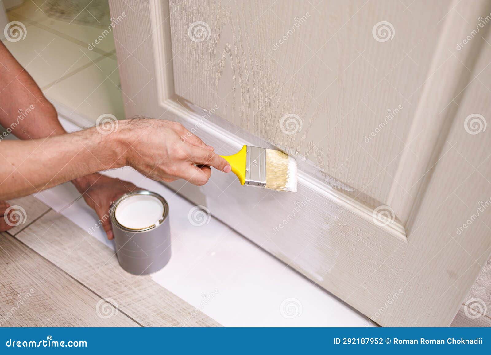 The Process of Painting Doors White with a Brush. Repair Staining the