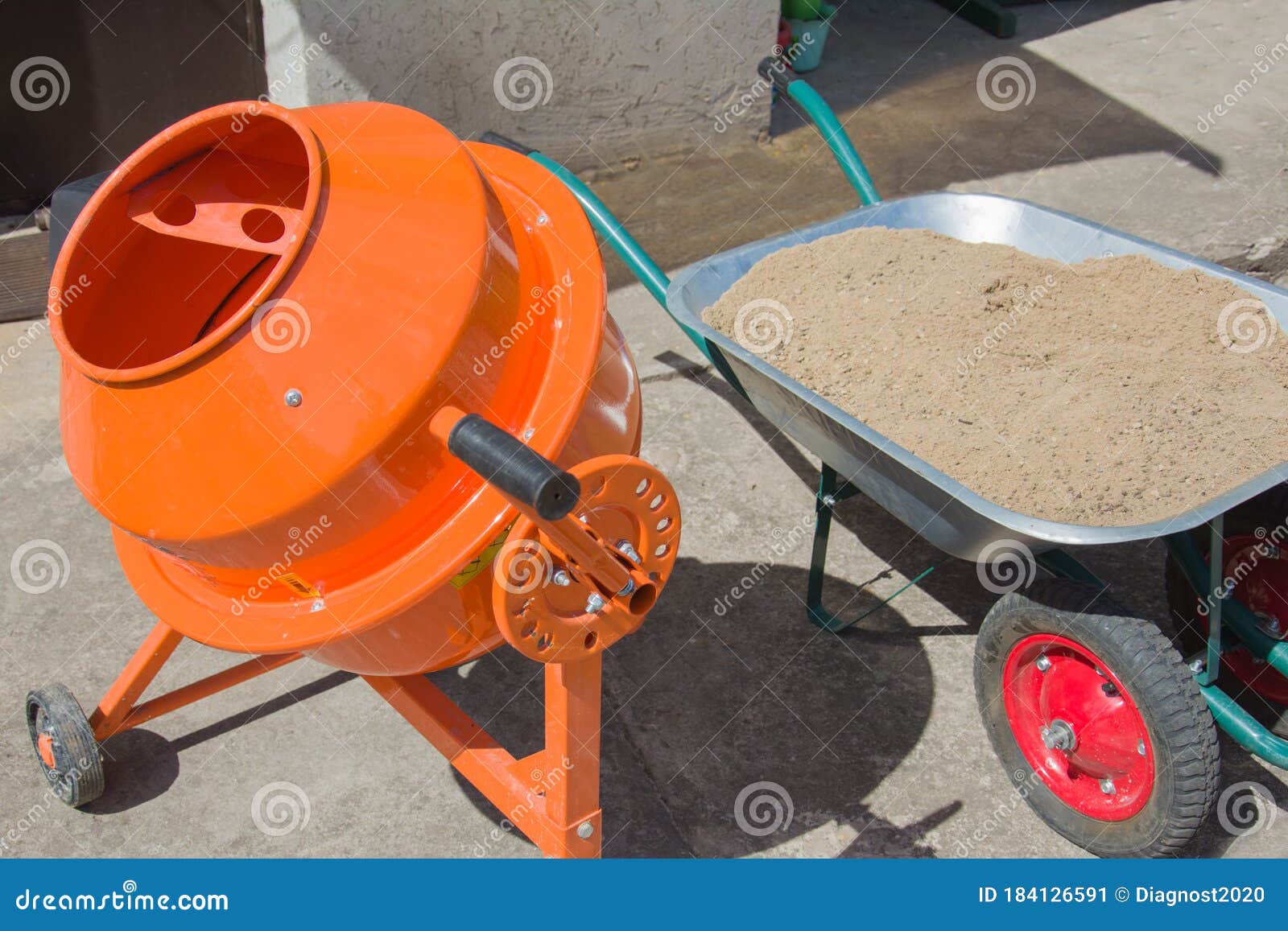 Process Pouring the Foundation. Orange Concrete Cement Mixer Machine is at Construction Site