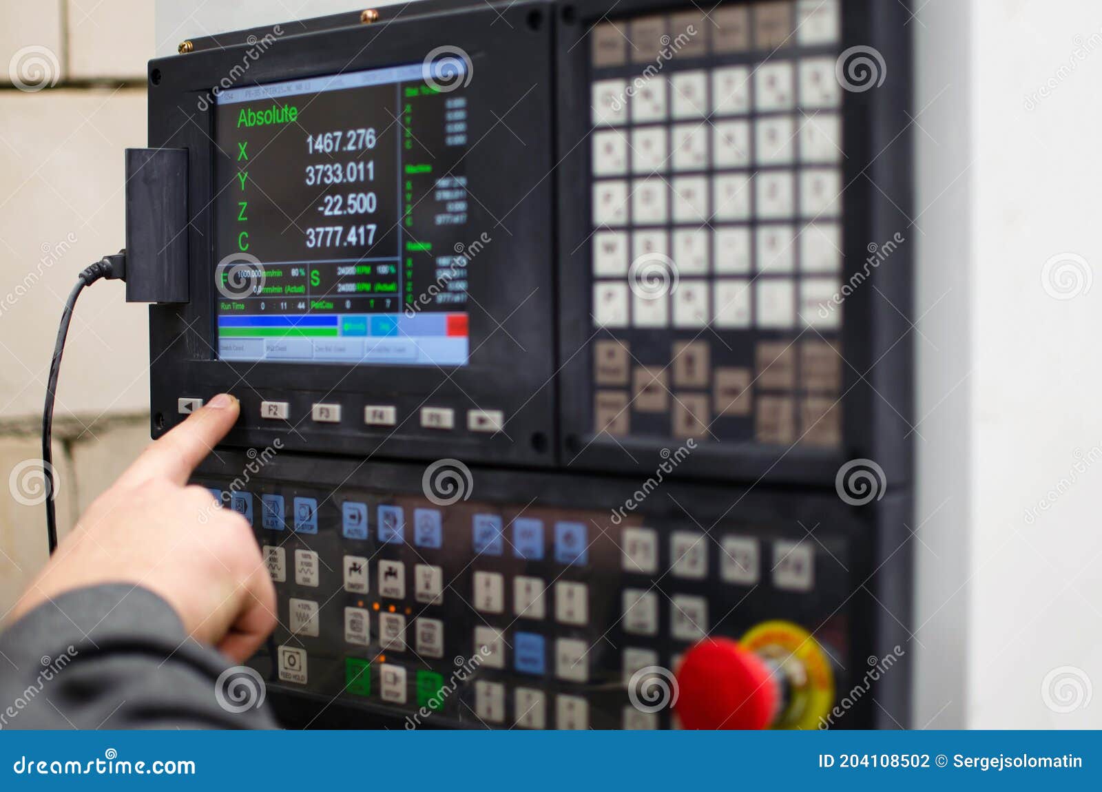 The Process of Programming a CNC Machine. Entering Data into a Computer