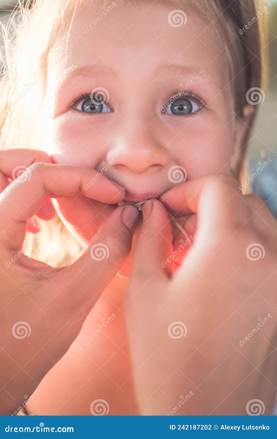 The Process of Removing a Baby Tooth Using a Thread Stock Photo Image of girl, oral 242187202
