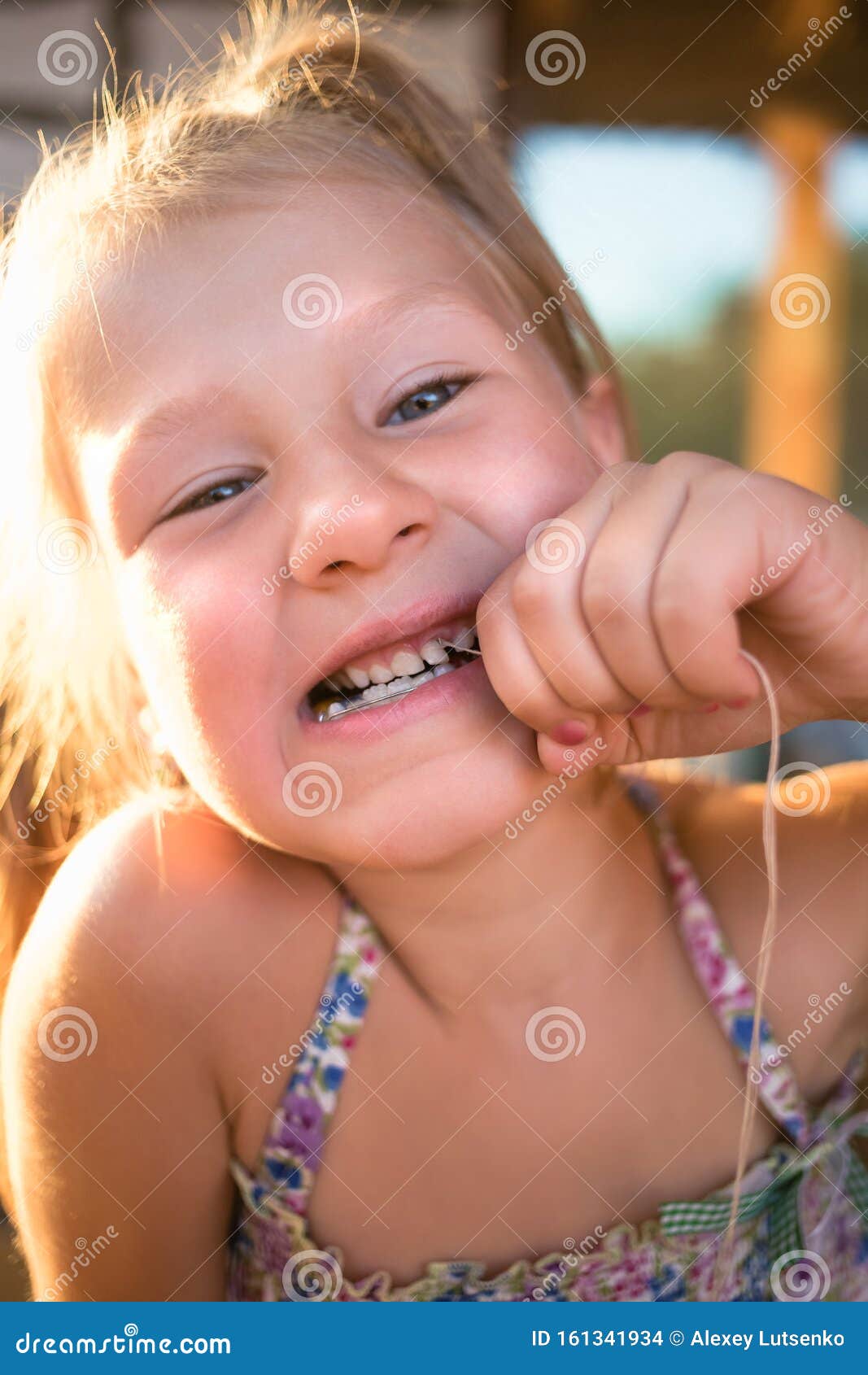 The Process of Removing a Baby Tooth Using a Thread Stock Photo Image