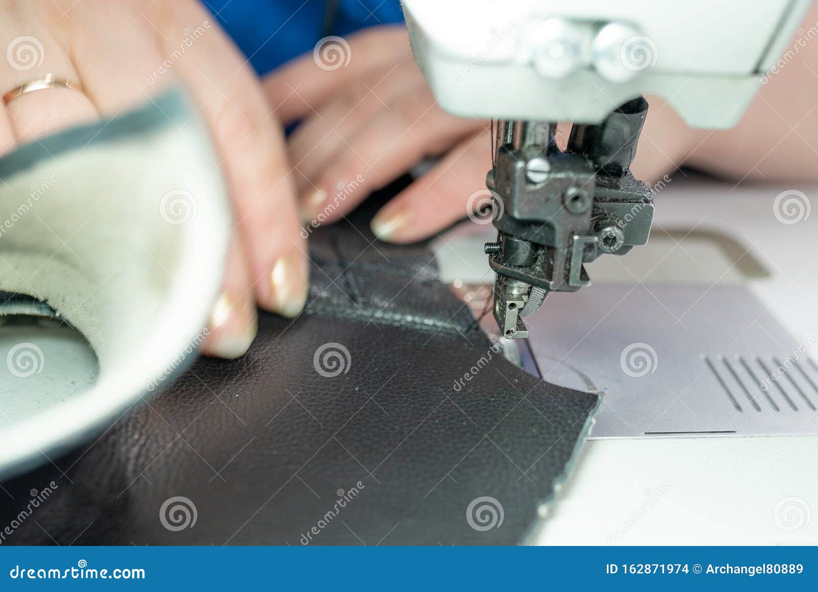 The Process of Sewing Shoes on a Sewing Machine. Shoe Production Stock