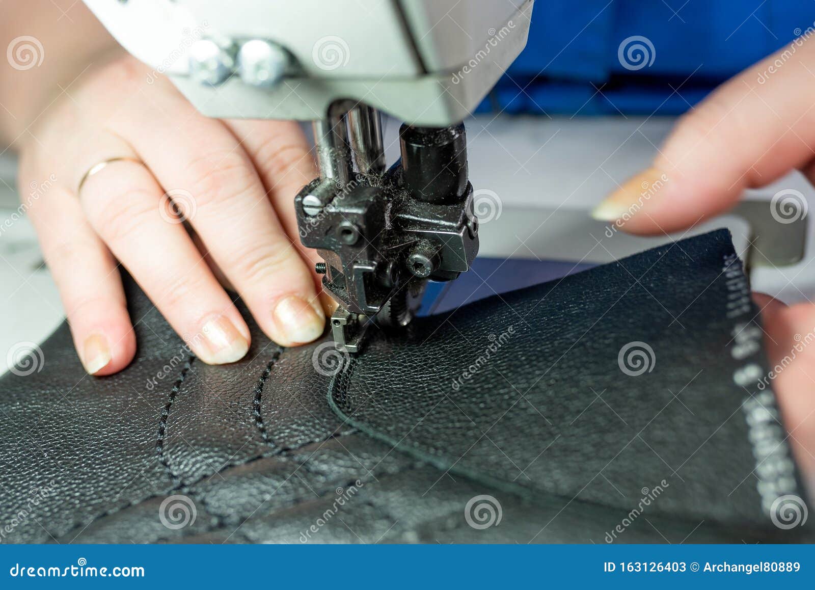 The Process of Sewing Shoes on a Sewing Machine. Shoe Production Stock