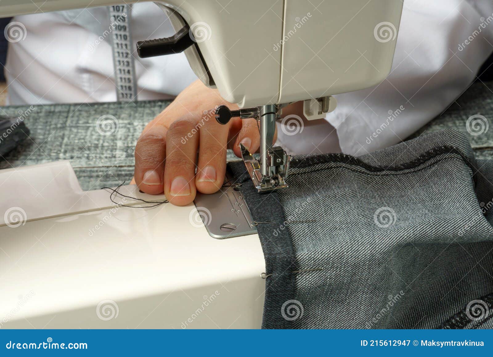 Process of Shortening Jeans Pants on a Sewing Machine Stock Image