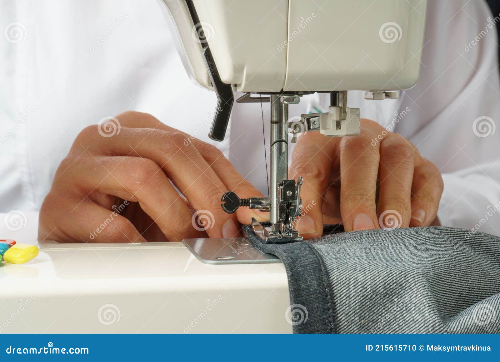 Process of Shortening Jeans Pants on a Sewing Machine Stock Photo