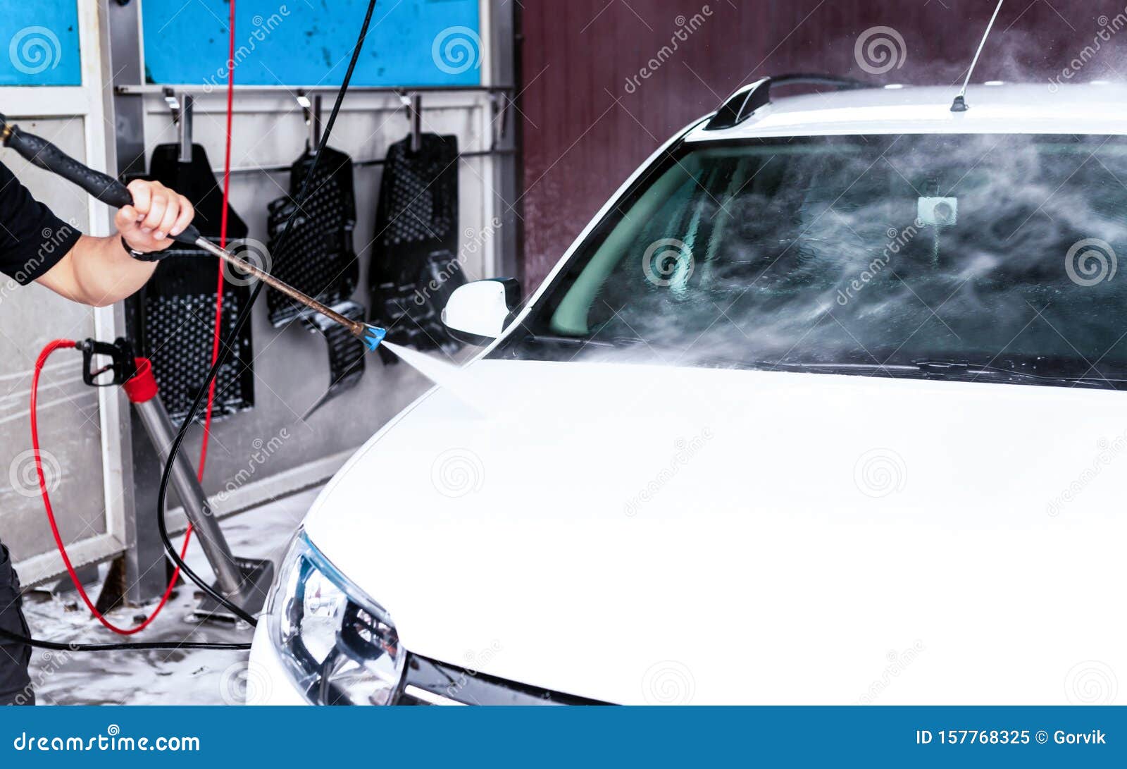 The Process of Washing a White Car Using a Pressure Washer Stock Image