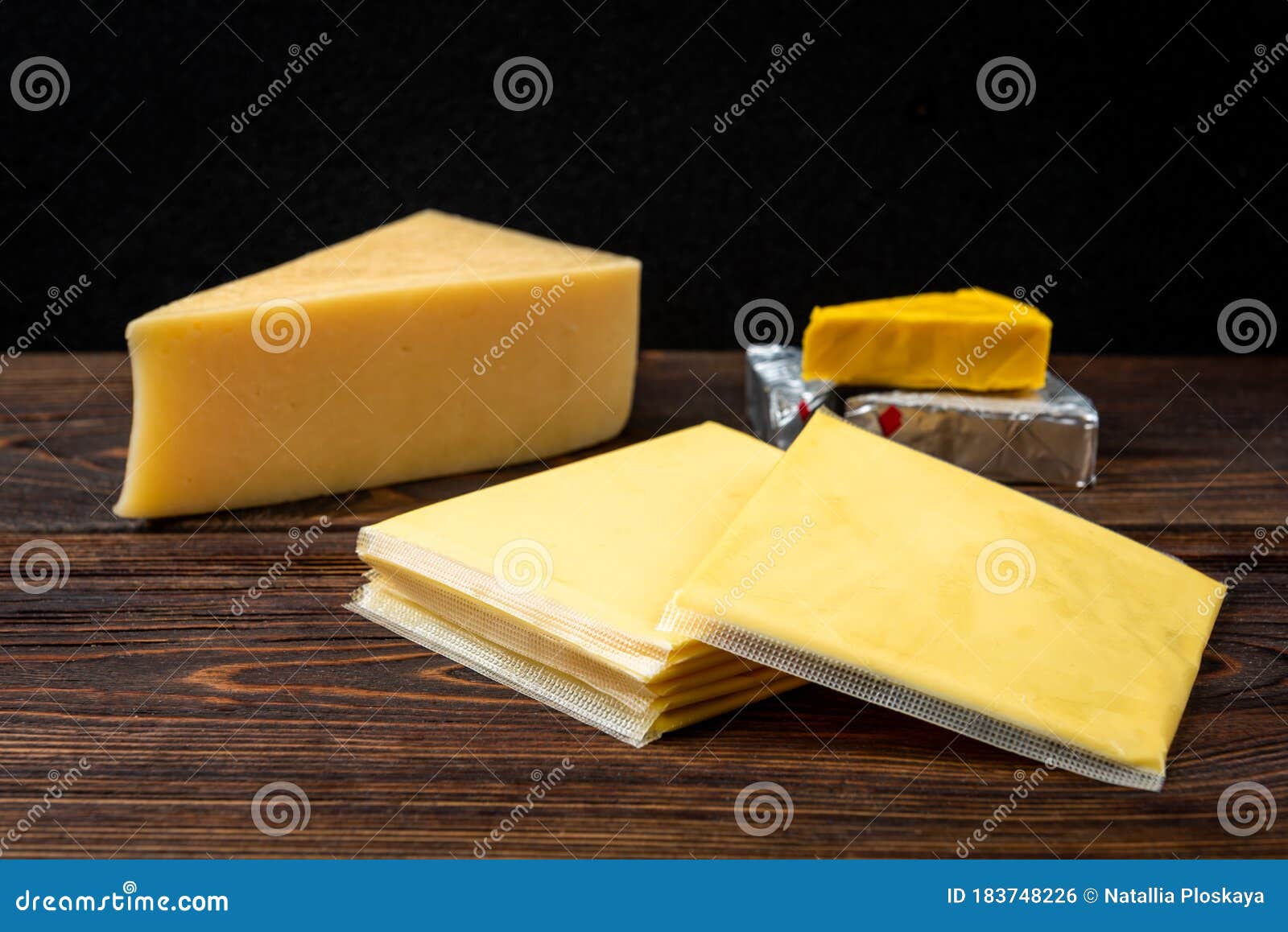 processed cheese on dark wooden background