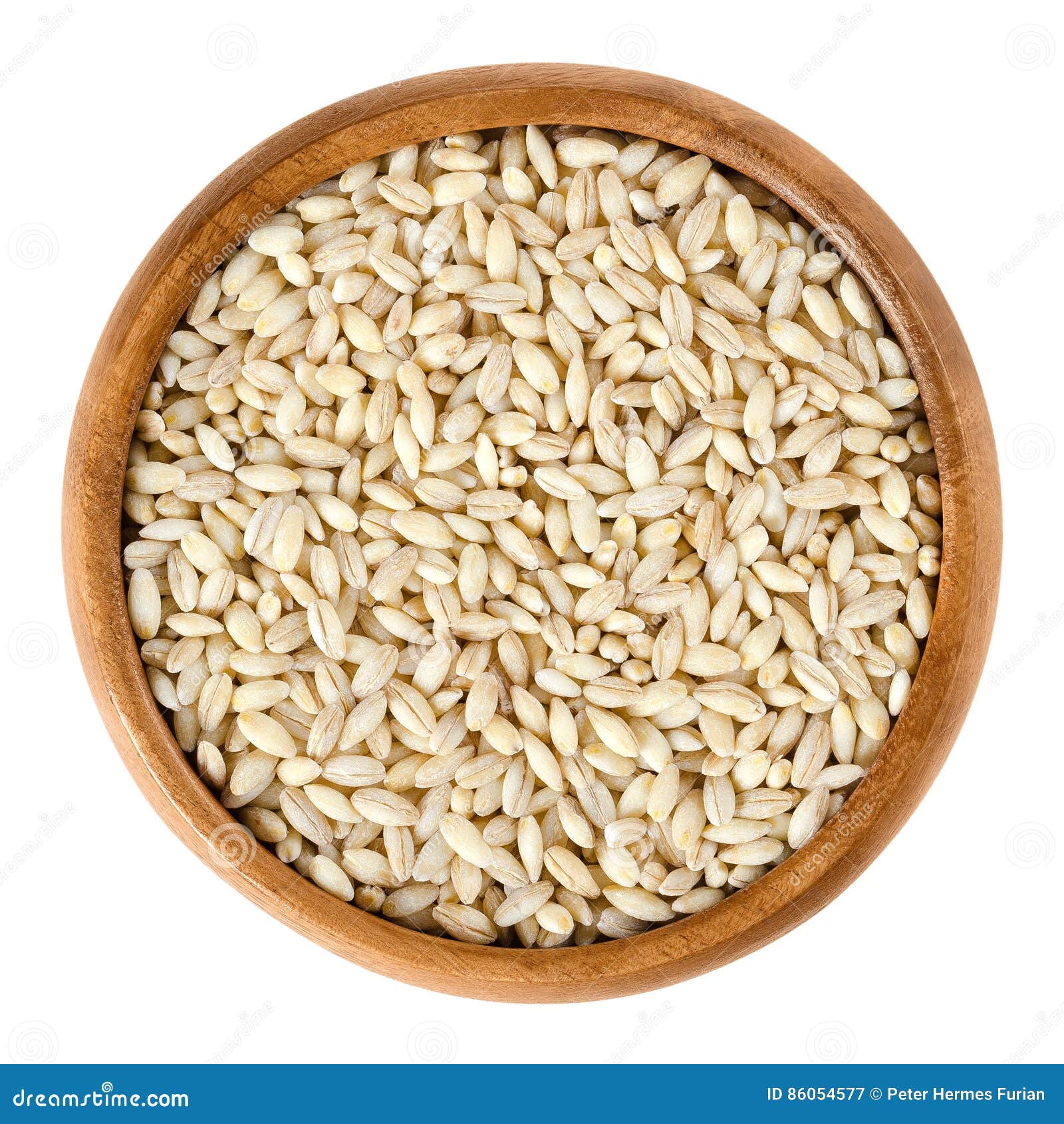 processed pearl barley in wooden bowl over white
