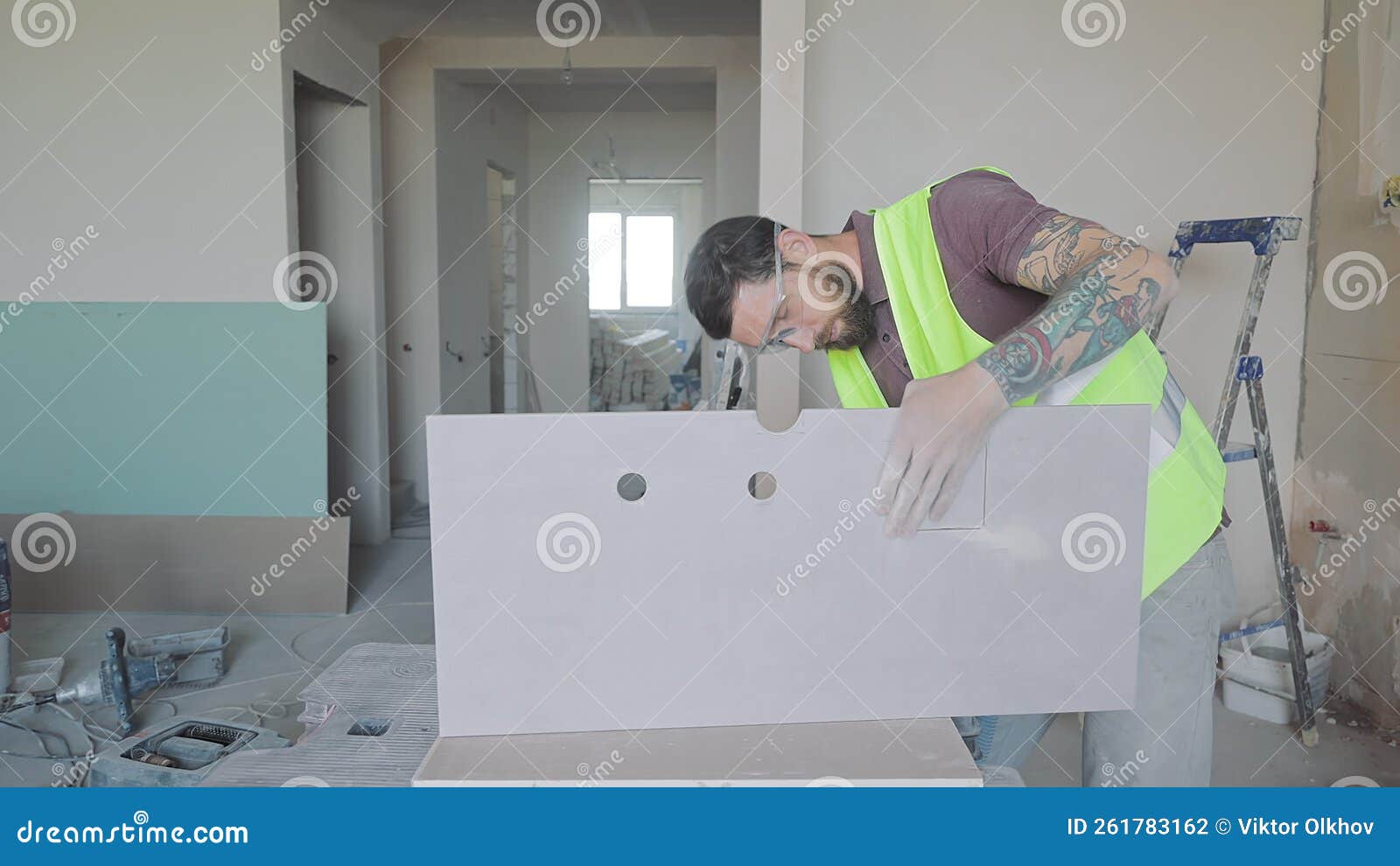 Processing of Ceramic Tiles. the Master Will Drill a Hole in the Tile