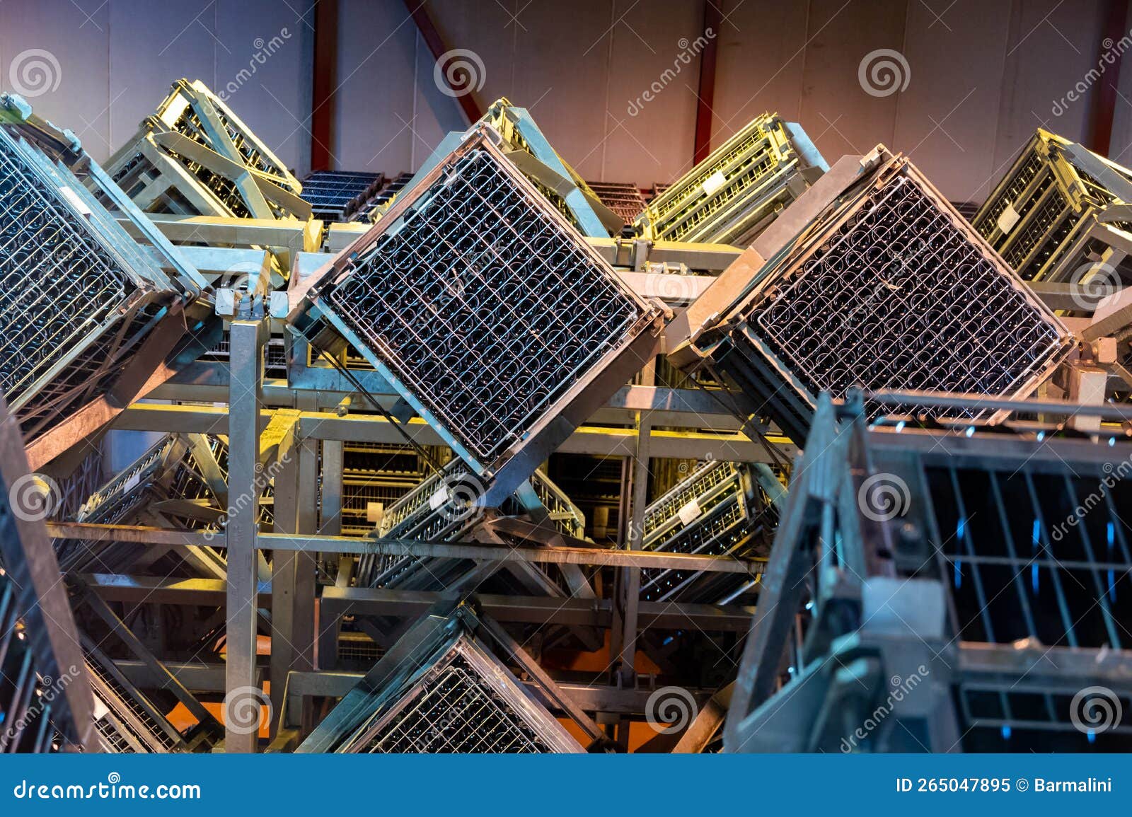 production of cremant sparkling wine in burgundy, france. automatically powered riddling remuage boxes on factory