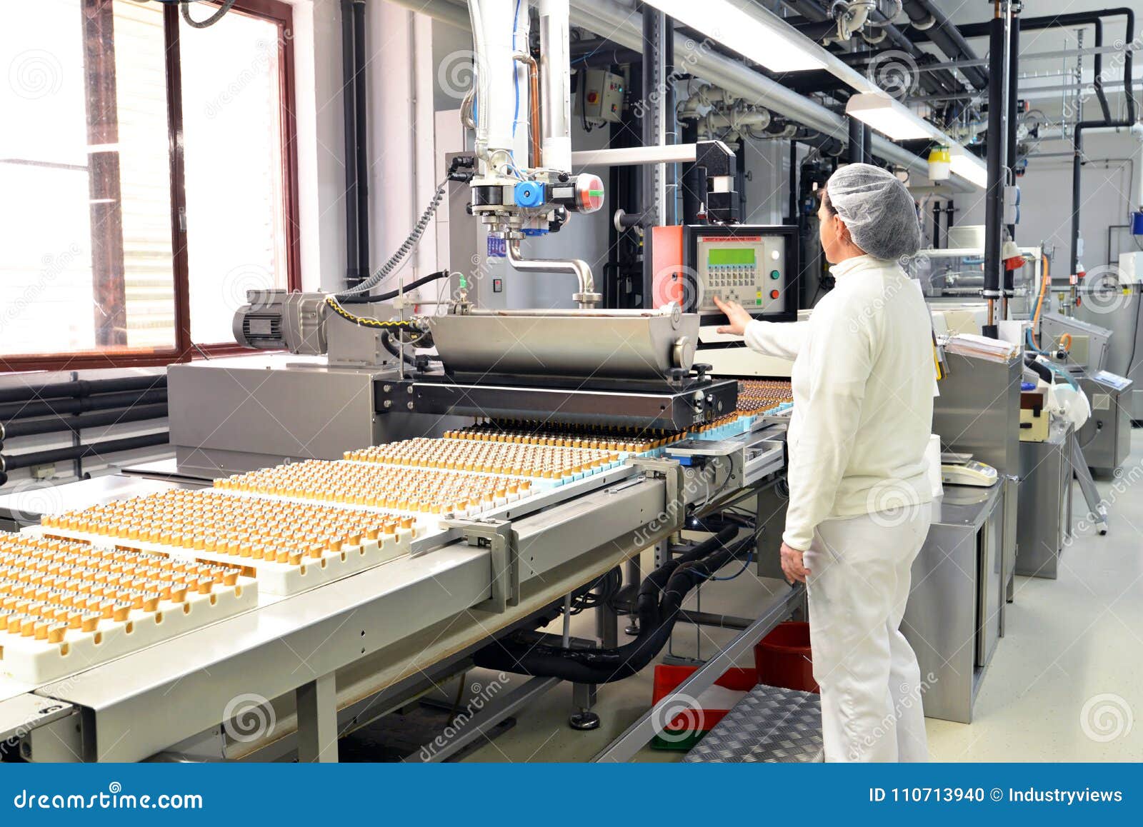 production of pralines in a factory for the food industry - conveyor belt worker with chocolate