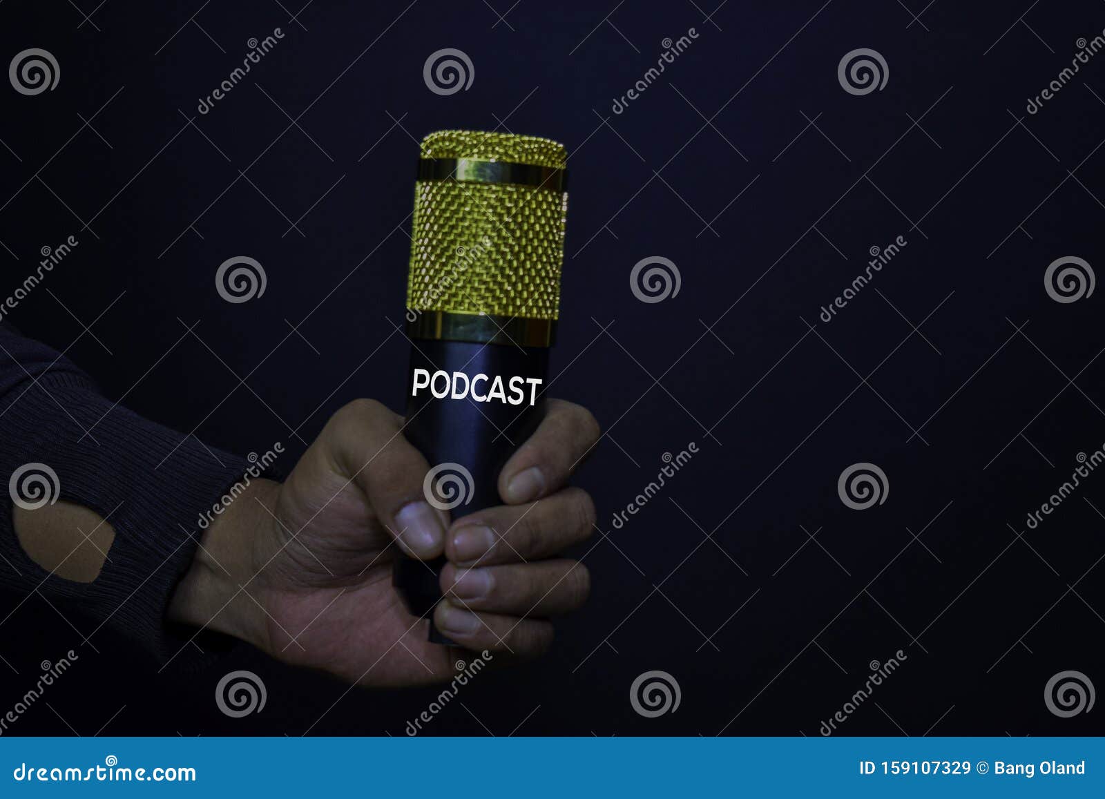 profesional microphone on hands  black background. podcast concept