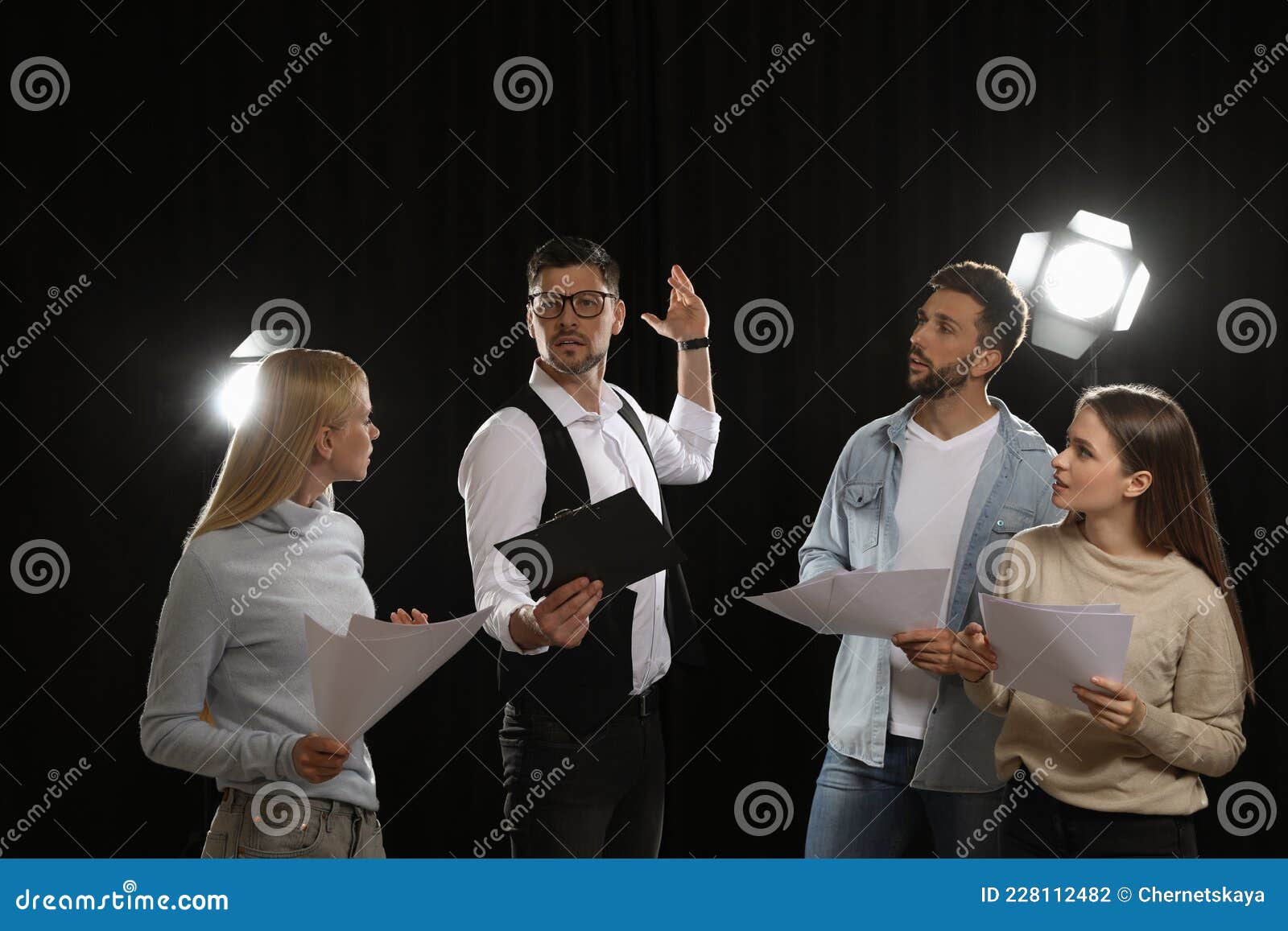 professional actors reading their scripts during rehearsal in theatre