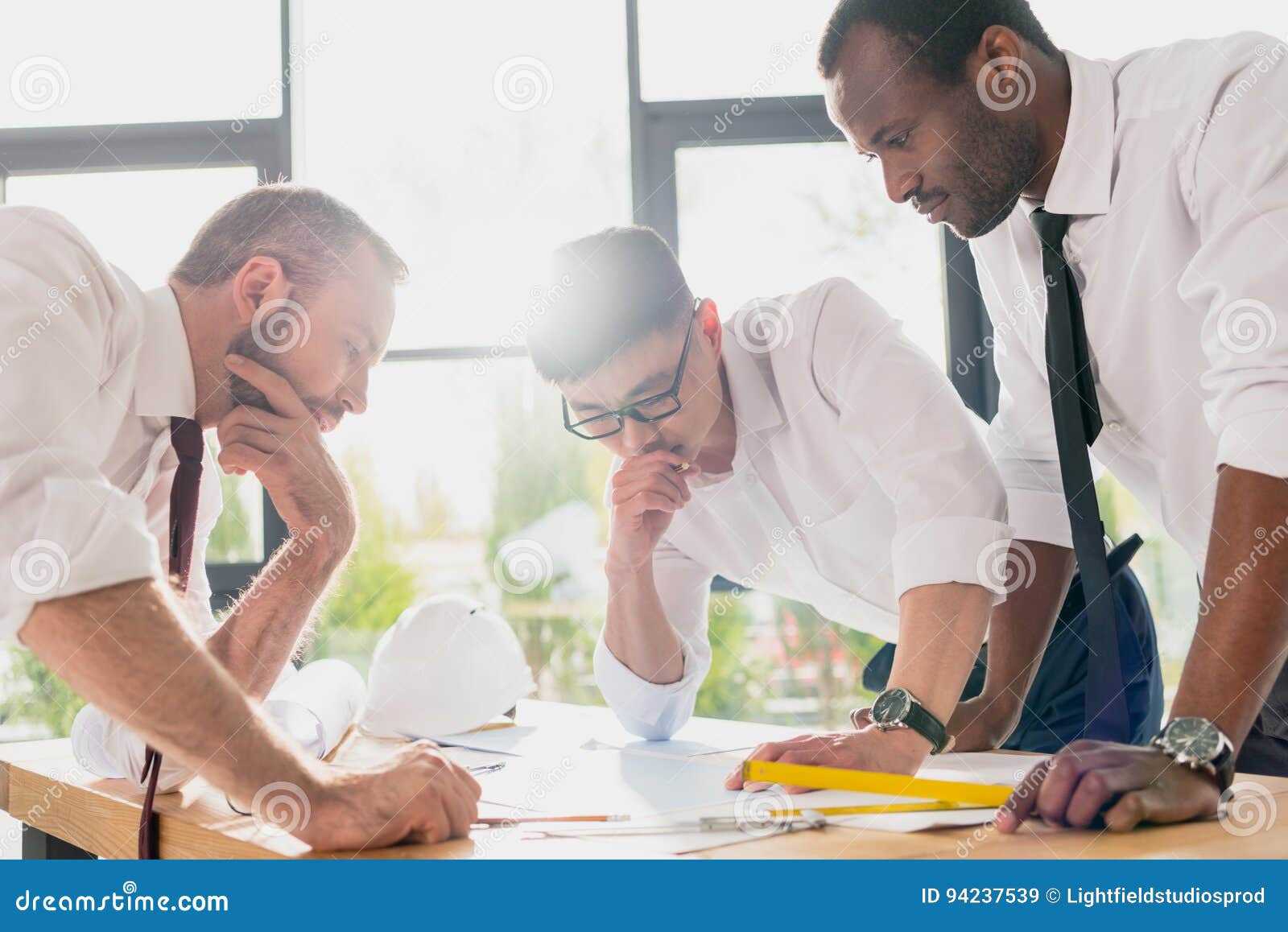 Professional Architects in Formal Wear Working at Modern Office Stock