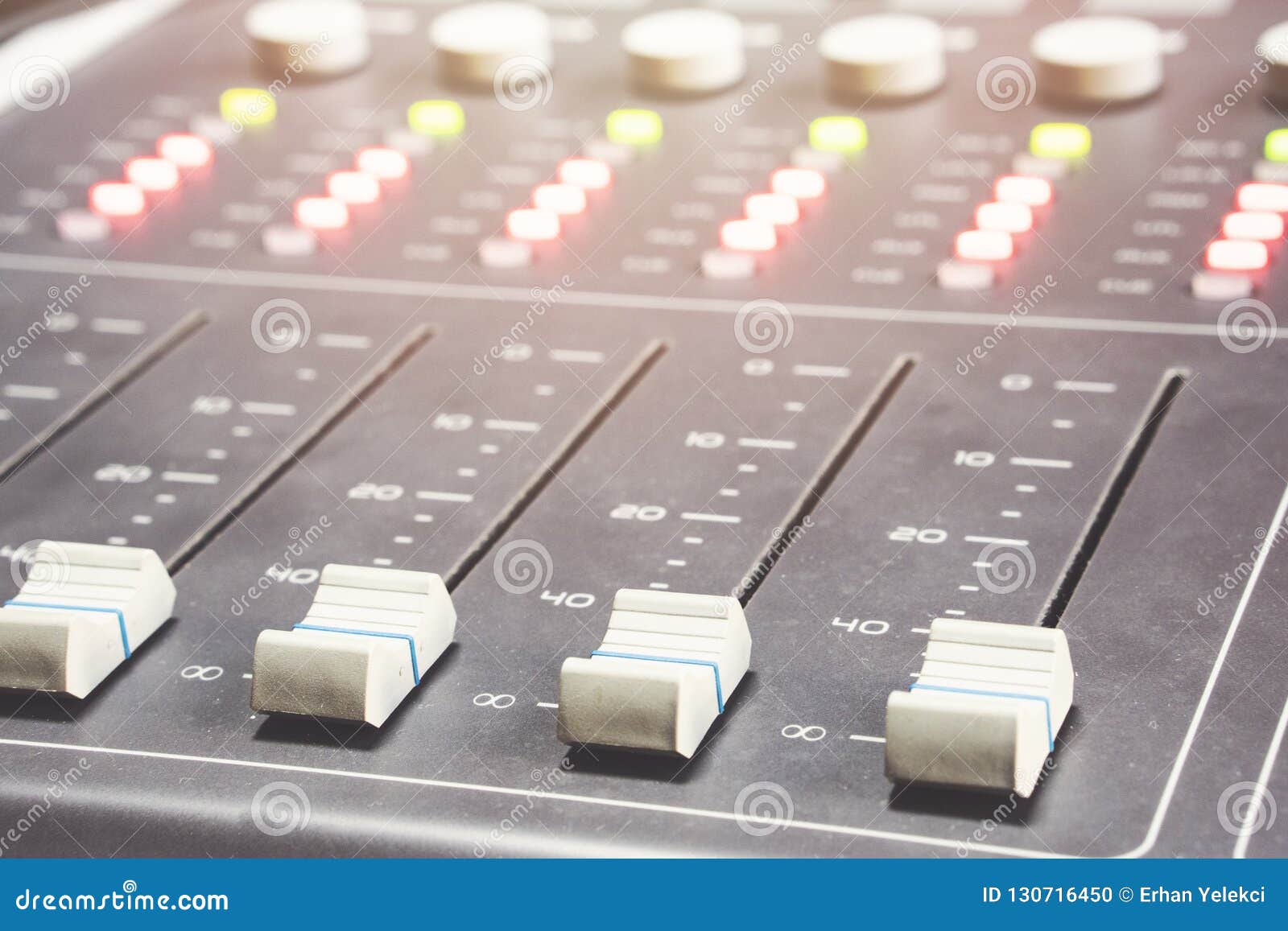 Professional Audio Mixing Console with Faders and Adjusting Knobs
