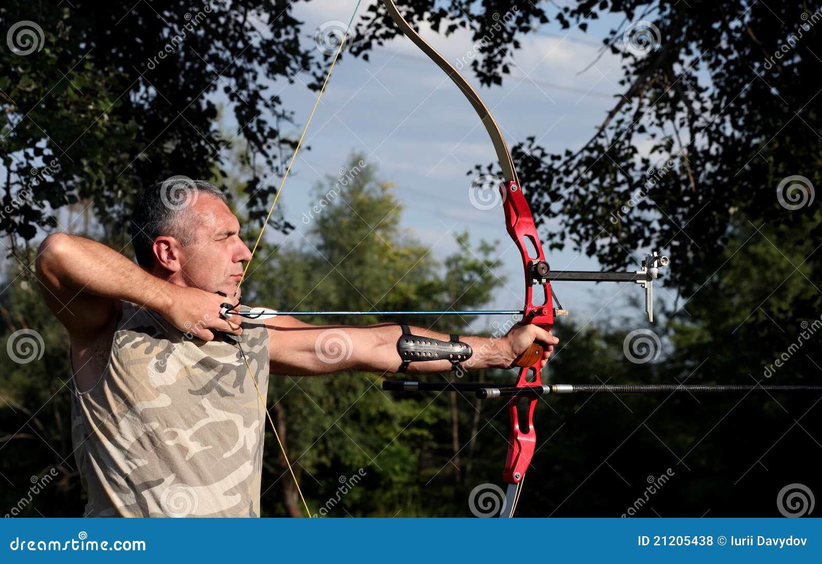 professional bowman aiming with bow and arrow