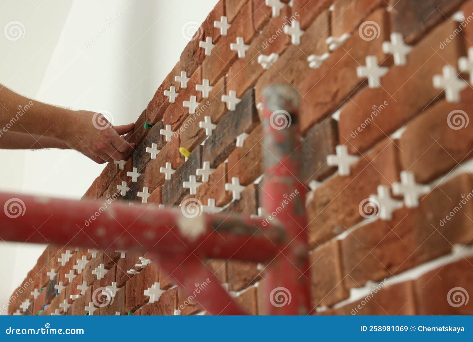 Professional Builder Gluing Decorative Brick on Wall, Closeup. Tiles