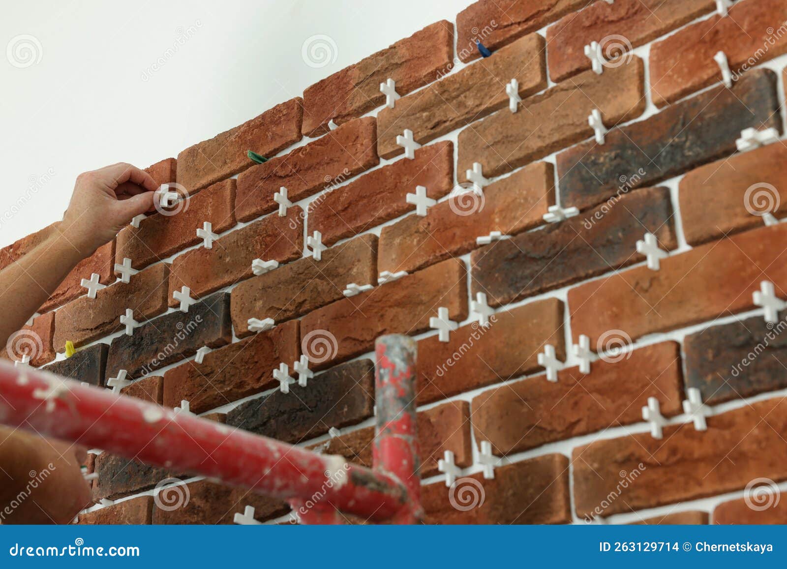 Professional Builder Gluing Decorative Brick on Wall, Closeup. Tiles