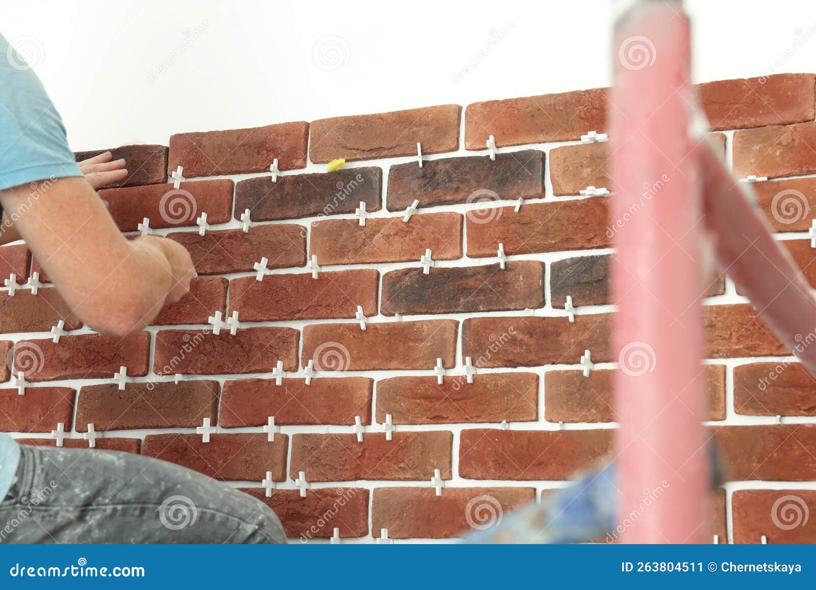 Professional Builder Gluing Decorative Brick on Wall, Closeup. Tiles
