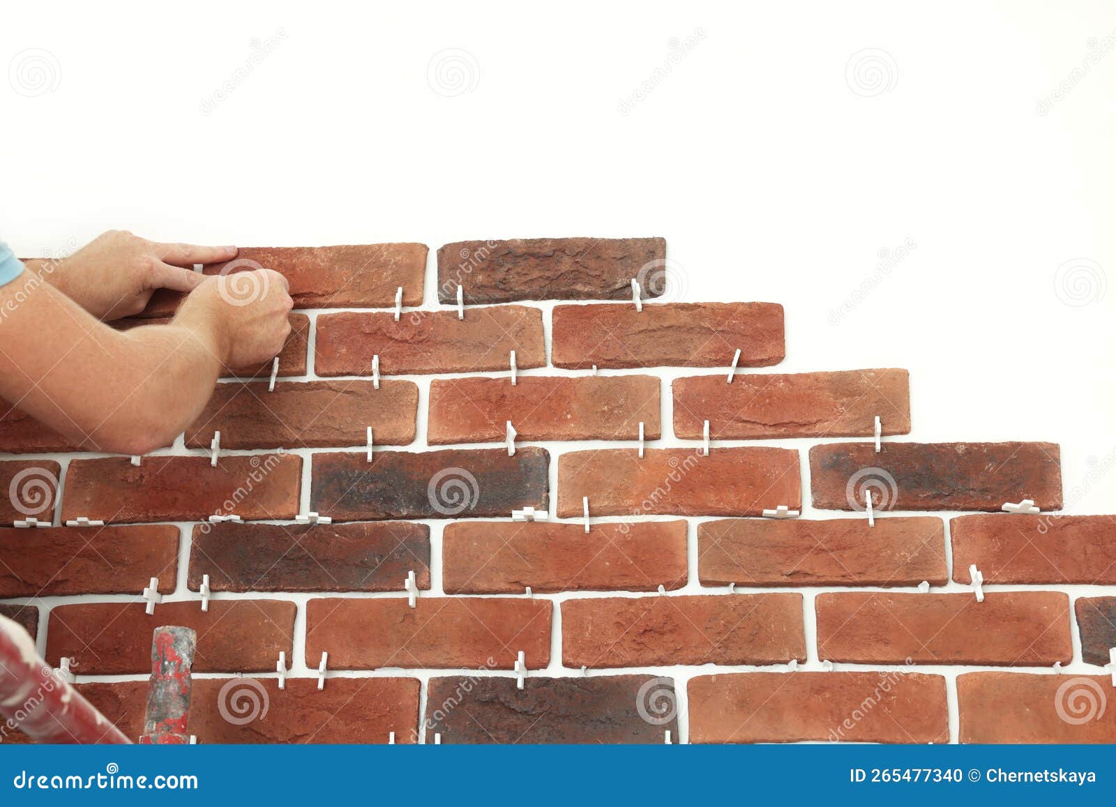 Professional Builder Gluing Decorative Brick on Wall, Closeup. Tiles Installation Process Stock