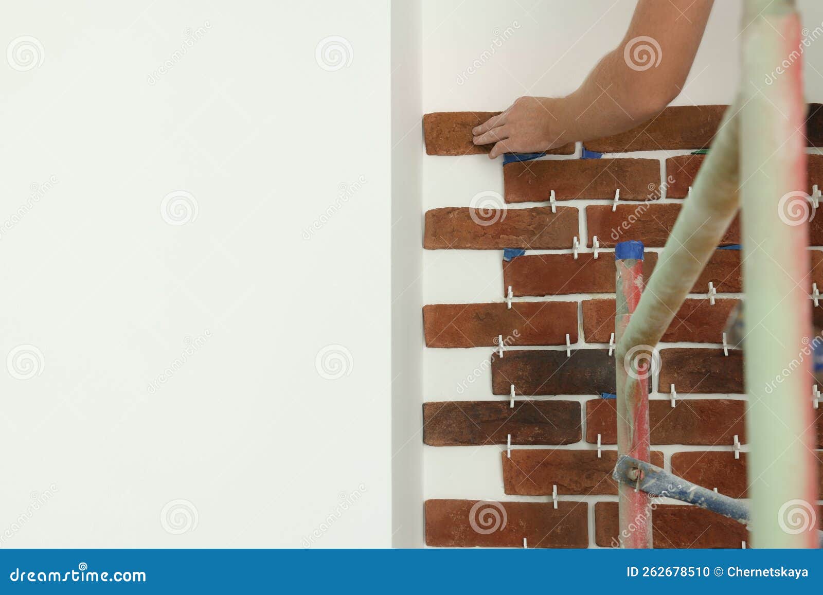 Professional Builder Gluing Decorative Brick on Wall, Closeup. Tiles Installation Process Stock