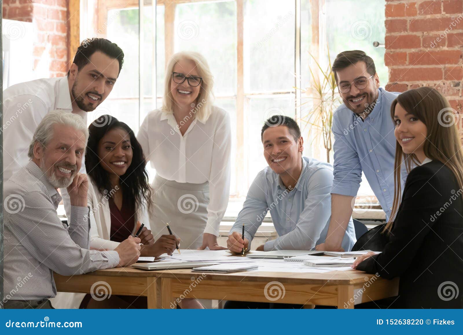 professional business team young and old people posing at table