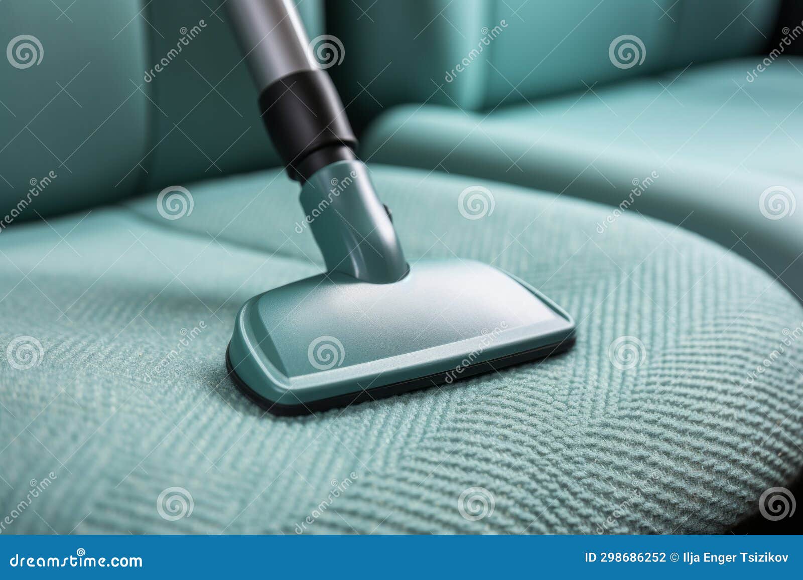 Professional Car Cleaner Using a Powerful Vacuum To Thoroughly Clean