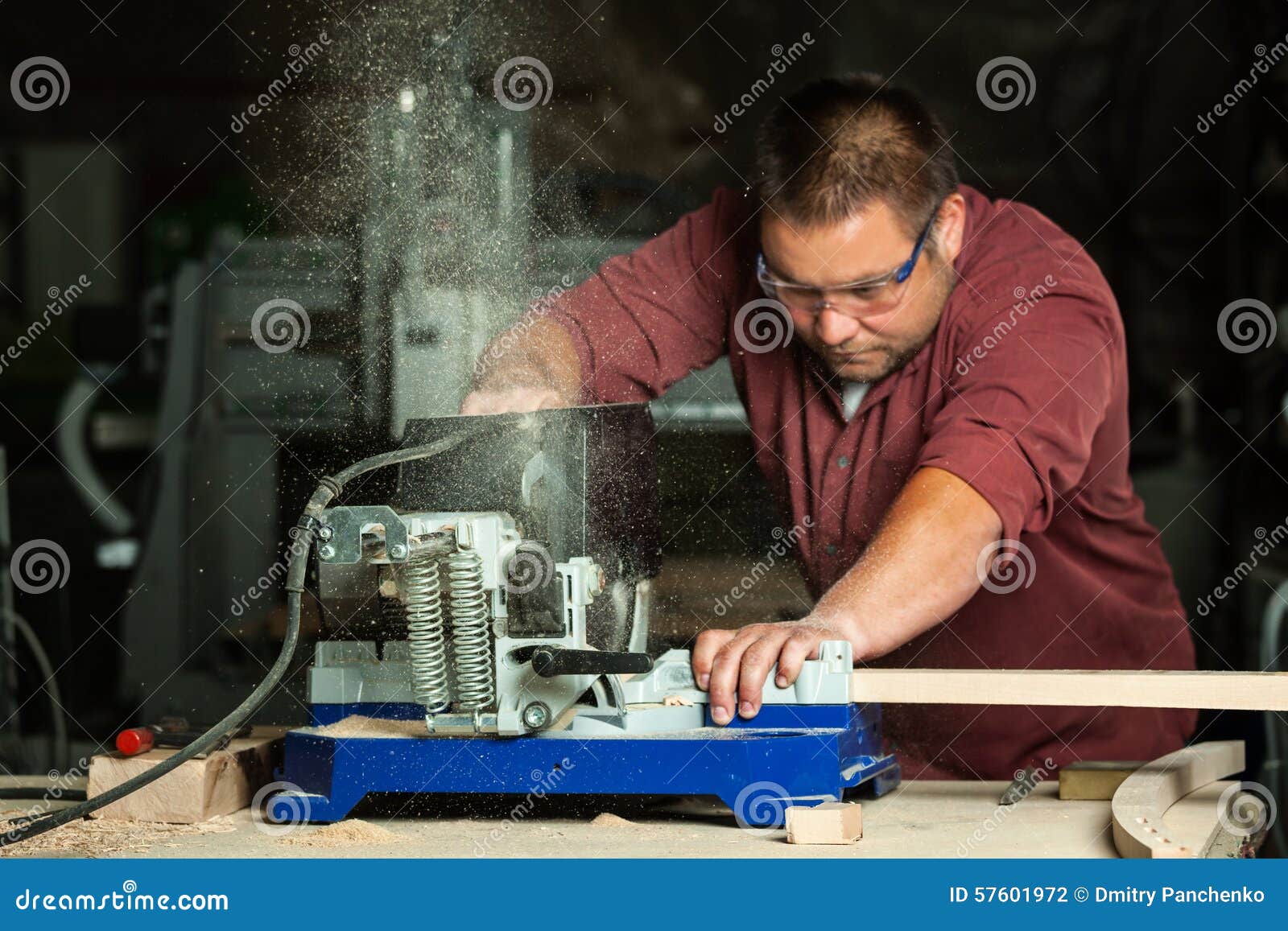 Professional Carpenter Working with Sawing Machine. Stock Photo Image