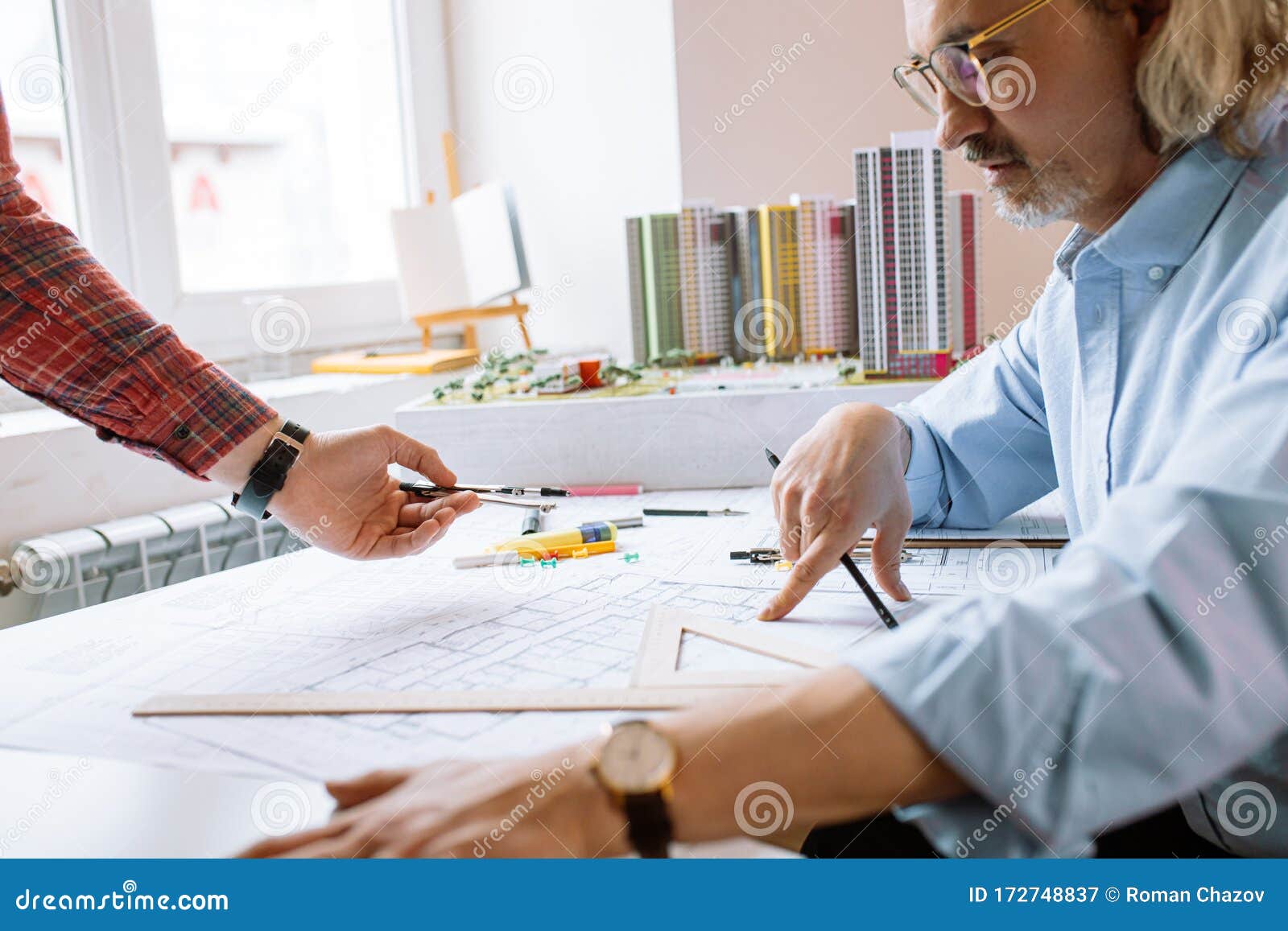 Professional Civil Engineer Working with Documents, Drawings in Office