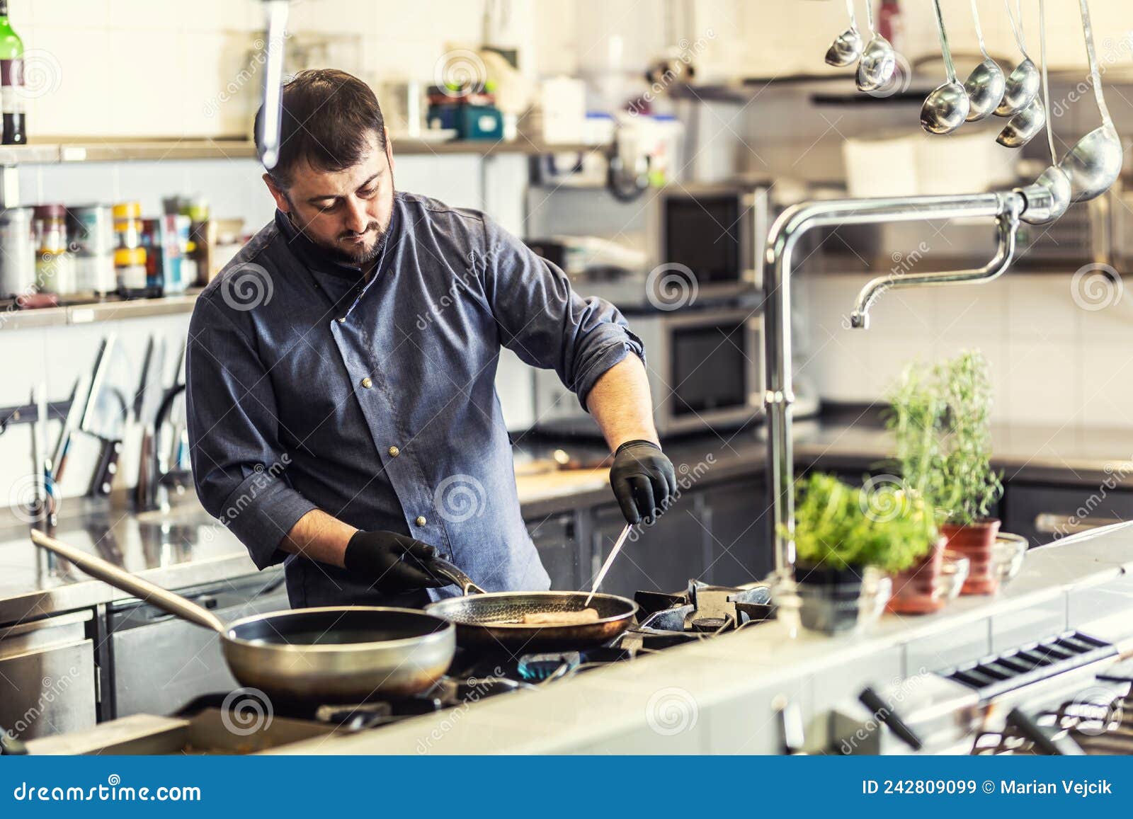 Professional Chef Cooks in the Restaurant on Two Pans Stock Image
